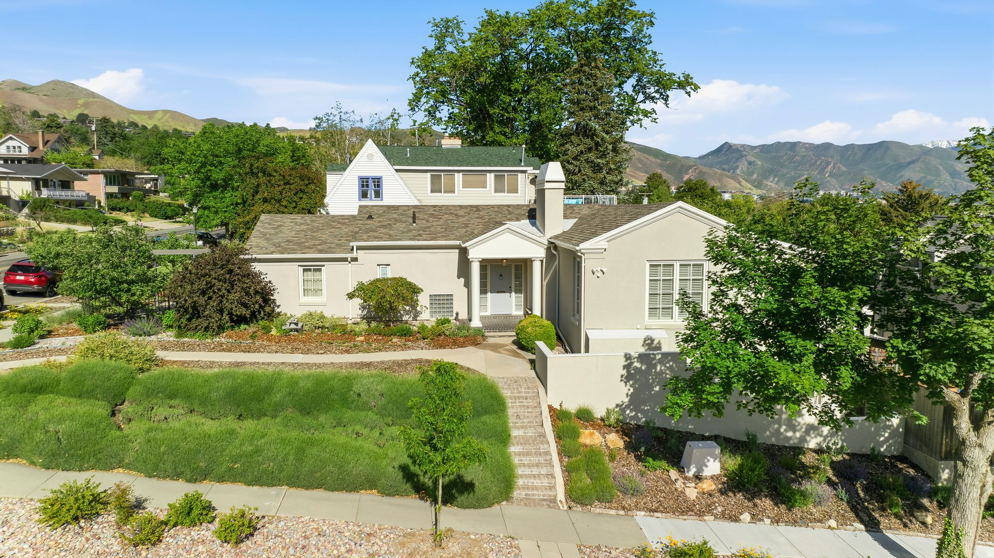 PRICE IMPROVEMENT!  Nestled on a friendly, tree-lined street with unparalleled access to the foothills and downtown, this 1936 classic jewel stands as a testament to the craftsmanship of the architects Cannon and Fetzer. Combining historic integrity with high-end modern upgrades, this home offers a rare opportunity to own a piece of local history, Exudes sophistication from the hardwood floors to the dentil and crown moldings, the grand foyer with striking wrought iron balustrade sets a tone of refined elegance.  Sturdy concrete construction, along with new wood windows and added exterior foam insulation maintain the home's historic character while providing modern energy efficiency. Enjoy crisp mornings in the heated sunroom or take in mountain and city views from the south deck. 90% efficient furnace, 2 gas water heaters, and a newer warranted roof for peace of mind. Outdoor spaces are landscaped with sprinklers, and drip, grow boxes.   All this is steps away from walking and biking paths leading to City Creek, U of U, local hospitals and foothill trails. Discover the perfect balance of historic charm and urban conveniences. Square footage figures are provided as a courtesy estimate only and were obtained from independent appraiser measurements. Buyer is advised to obtain an independent measurement.
