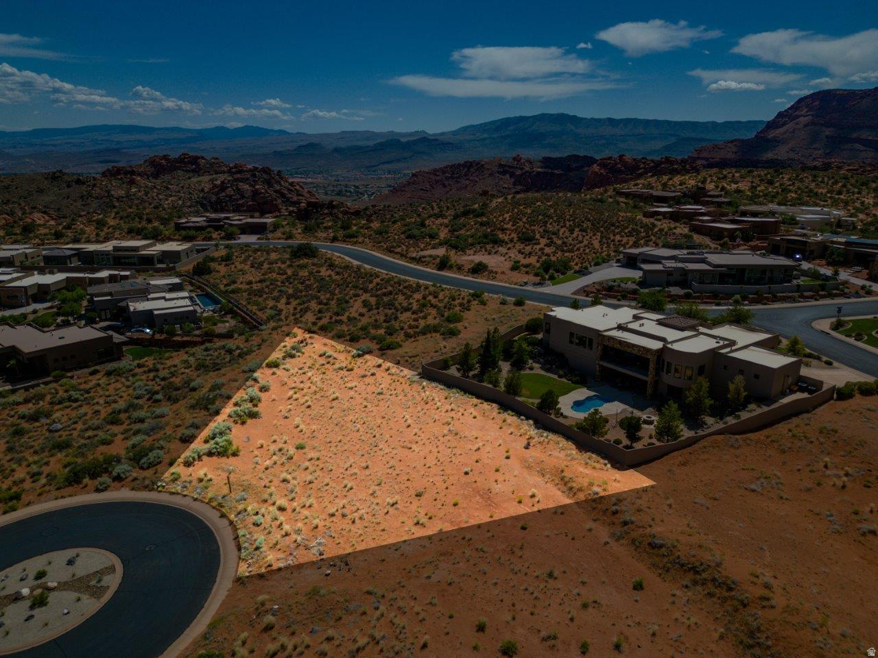 Warning: building here may ruin ordinary living forever. Welcome to The Ledges, where the views steal the spotlight and every sunrise feels like a private showing put on by nature. Tucked away on a quiet cul-de-sac, this exceptional homesite offers the perfect setting to create a custom retreat surrounded by Southern Utah's iconic red rock beauty. Imagine expansive glass walls, seamless indoor-outdoor living, and a design that captures every breathtaking angle. Spend your mornings on the golf course, your afternoons exploring nearby Snow Canyon, and your evenings watching the desert sky light up in unforgettable color. Peaceful, dramatic, and undeniably inspiring, this is more than just a homesite. It's the beginning of the lifestyle you've been dreaming about.