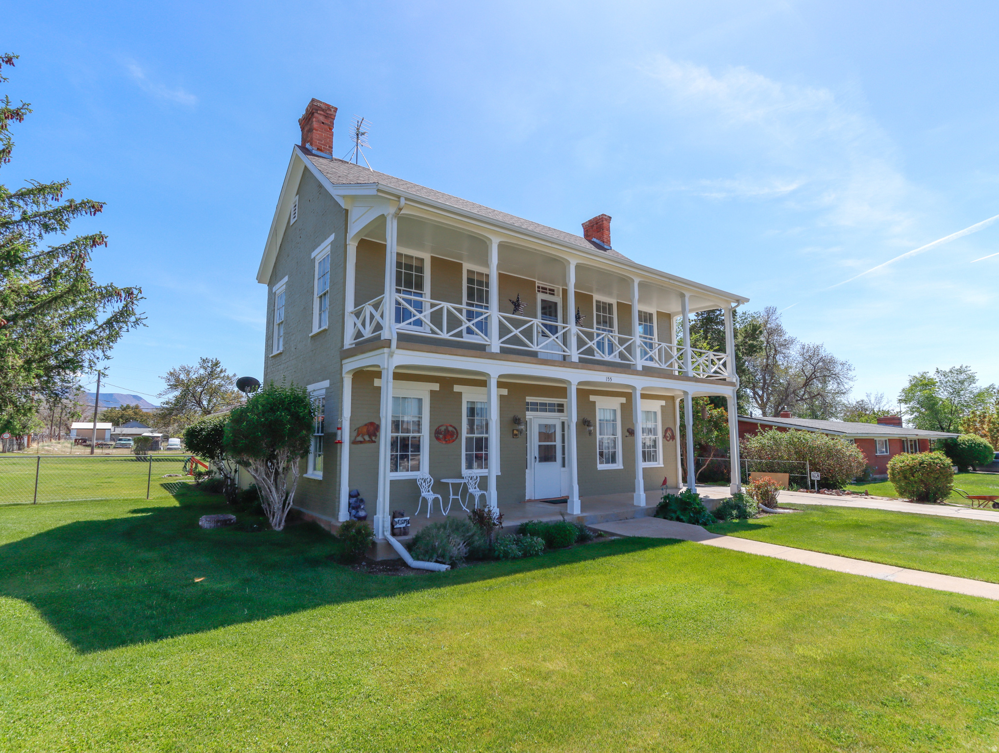 Timeless charm meets modern function in this inviting home, thoughtfully designed by a Danish architect and listed on the National Register of Historic Places. Rich woodwork, classical moldings, and original front windows showcase its historic character, while major updates like all new plumbing, all new electrical, new windows, and central heating and AC bring everyday comfort. Set on a spacious fenced lot, the property offers a garden area, cellar, several orchard fruit trees, powered 20-by-50 workshop, sunny back patio, and two new storage sheds, along with animal rights and a 0.62 share of pressurized irrigation--ideal for a rural lifestyle. Enjoy quiet mornings and shaded afternoons from the north-facing porch or balcony, all within walking distance to parks, schools, and local amenities. A rare opportunity to own a stunning piece of history with room to live, grow, and create.