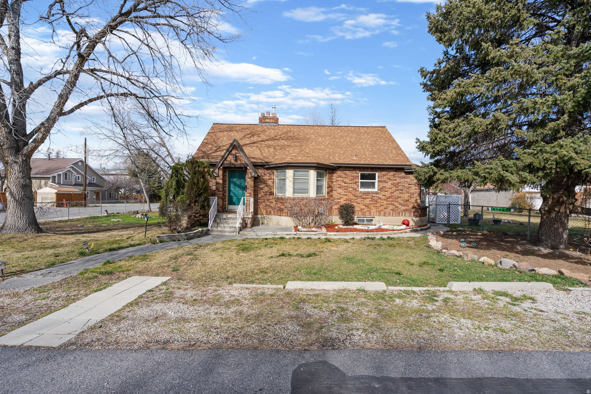This charming six-bedroom, three-bathroom brick bungalow has a fully finished basement and so much versatility!  Full of character and loaded with updates, this classic brick bungalow offers timeless curb appeal with mature trees, a spacious yard, a two-car garage, and a long driveway for plenty of parking.  Inside, the bright and open living room features rich hardwood-style flooring, a fireplace, and an easy flow to the rest of the home.  With two bedrooms and one bathroom on the main floor and another bedroom on the second level, there is plenty of space to be comfortable. The fully finished basement features a kitchen, three bedrooms, one bathroom, and washer/dryer hookups.  Enjoy outdoor time on the covered back patio in the private fenced-in yard.  This well-cared-for home has so much to offer!