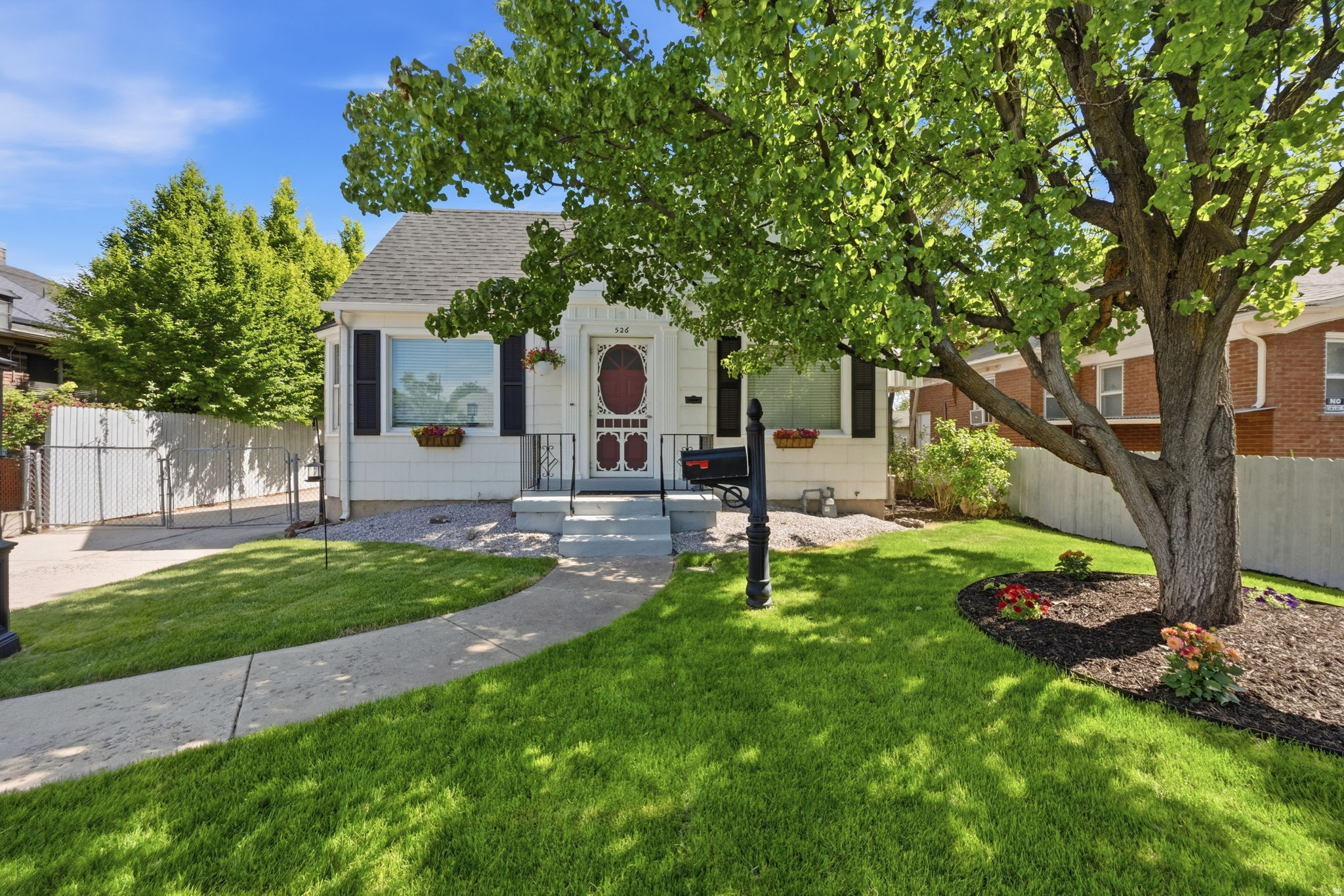 Warm, welcoming, and full of character, this home has the big-ticket updates buyers look for, including a brand-new roof, recently updated electrical, central air conditioning, a new water heater, a new refrigerator and a freshly painted interior and exterior. Inside, hardwood floors and built-ins set a warm tone, while the fireplace creates a cozy space for gatherings of friends and family. The kitchen keeps its original period backsplash (a cheerful yellow with red accents), as well as its pull-out bread board. The original kitchen cabinets, drawers, and sink are all newly refinished. The lower level includes one or two bedrooms and a room for a home office or hobbies. Outside, the fully fenced private backyard, kept lush by an automatic sprinkling system, offers room for dogs to play, while the gazebo-covered patio is ready for entertaining, relaxing, and installing a future hot tub. A heated garage (with a workshop), adjoining carport, and a long driveway provides ample off-street parking. Nearby bus stops connect to downtown, TRAX, and the U of U, while cafs, the 9 Trail, bike paths, and the green space of Liberty Park are all just outside your door. Timeless character, major upgrades and an unbeatable location  your new home truly has it all.