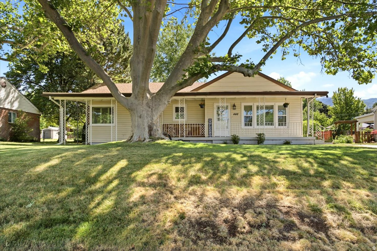 Nestled on nearly a quarter-acre, this charming Kaysville home with plenty of updates and brand NEW windows welcomes you with beautiful landscaping, mature trees, and an extended driveway that creates excellent curb appeal. Inside, the inviting front living room provides the perfect space for entertaining guests and flows seamlessly into the well-appointed kitchen, featuring granite countertops, stainless steel appliances, and pantry. Good-sized eating area open to the spacious family room offering a cozy built-in gas fireplace and brand NEW sliding glass door that leads to the expansive, fenced backyard. Outdoor amenities include a 21'X28' covered patio, fire pit, and storage shed, creating an ideal setting for relaxation and gatherings. A myriad of organic vegetables lines the back yard fence, growing beautifully and ready for your harvest throughout the summer. The primary bedroom suite is highlighted by a large brand NEW window overlooking the backyard. A second bedroom offers flexibility for home office, exercise room, library, study, or guest space. Additional features include a detached 2-car garage with new epoxy floors, and an expansive driveway with ample parking. Conveniently located near Heritage Park, the Kaysville Library, and plenty of dining and entertainment options, and I-15 for an easy commute. This home also provides easy access to the nearby mountains and countless outdoor recreation opportunities, including hiking, biking, skiing and more. Come experience all that this incredible home has to offer.