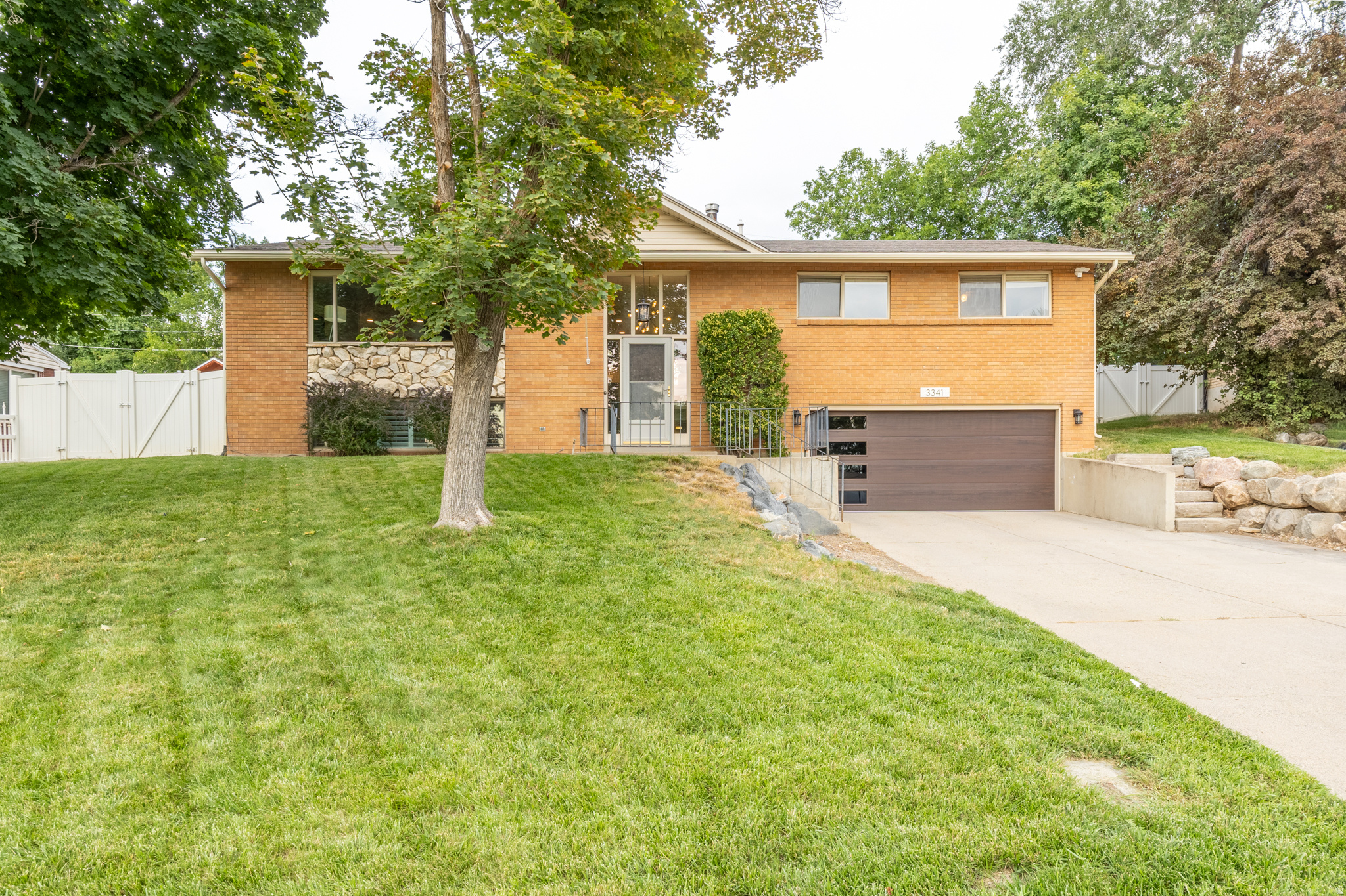 Best priced 2-car garage home in Bountiful.  This beautifully updated home offers quality finishes and inviting living spaces throughout.  The new chef's kitchen features custom walnut cabinetry, quartz countertops, a gas range, double ovens (including convection), a modern tile backsplash, and a hidden laundry chute.  The dining area opens to a private patio through a new sliding glass door, while the primary suite features french doors leading to a peaceful stone patio and koi pond with a waterfall feature.  The spacious main-level living room includes a gas fireplace and oversized picture window, with a second family room downstairs featuring plantation shutters and a wood-burning fireplace.  Additional highlights include an extra deep two-car garage with a new door, two furnaces, new rear gutters, heat tape, and a WYZE floodlight security camera.  Thoughtfully updated, well maintained, and ready to enjoy.