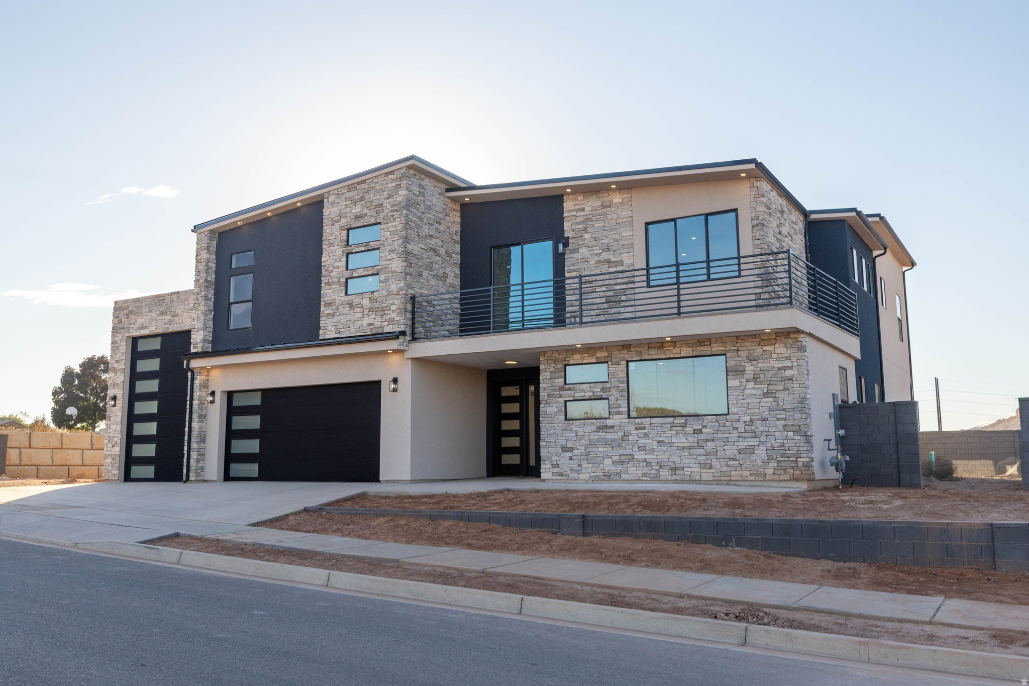 Brand-new modern 2-story by Next Level Homes on an elevated lot with red rock views. 3,700+ sq ft, RV garage, main-floor guest suite, big great room + butler's pantry. Upstairs primary w/ sitting area, loft w/ kitchenette plumbing, and view deck.