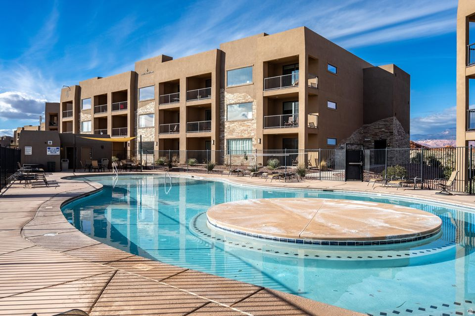 Welcome to this beautifully appointed 2-bedroom condo in Sand Hollow Resort! Thoughtfully designed and fully equipped, this turnkey unit is ready for use as a nightly rental, vacation retreat, or full-time residence. Located in a prime spot, the spacious deck offers great views of the large community pools and the golf course--perfect for relaxing and enjoying the scenery. Take advantage of the exceptional resort amenities, including a clubhouse, sports courts, fitness center, and more. This is resort-style living at its finest!