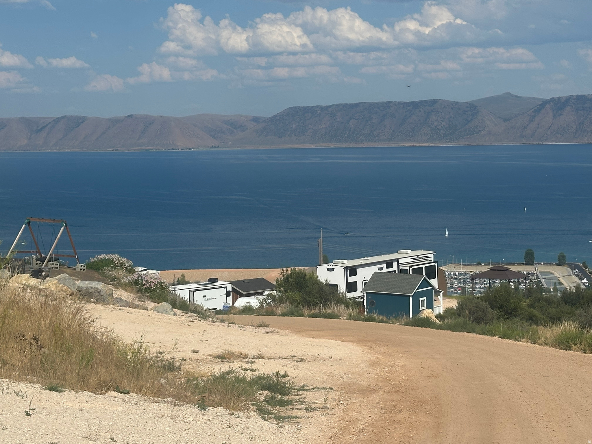 Incredible views of Bear Lake from this RV lot overlooking the marina and valley. Located in Swan Creek Village. lot has two 30-amp services and two water and sewer services.  Trailers can stay year round. Excellent opportunity to own in this highly sought after RV lot area in Bear Lake.  Utah State Park Marina just down off the hill; downtown Garden City 5 minutes.