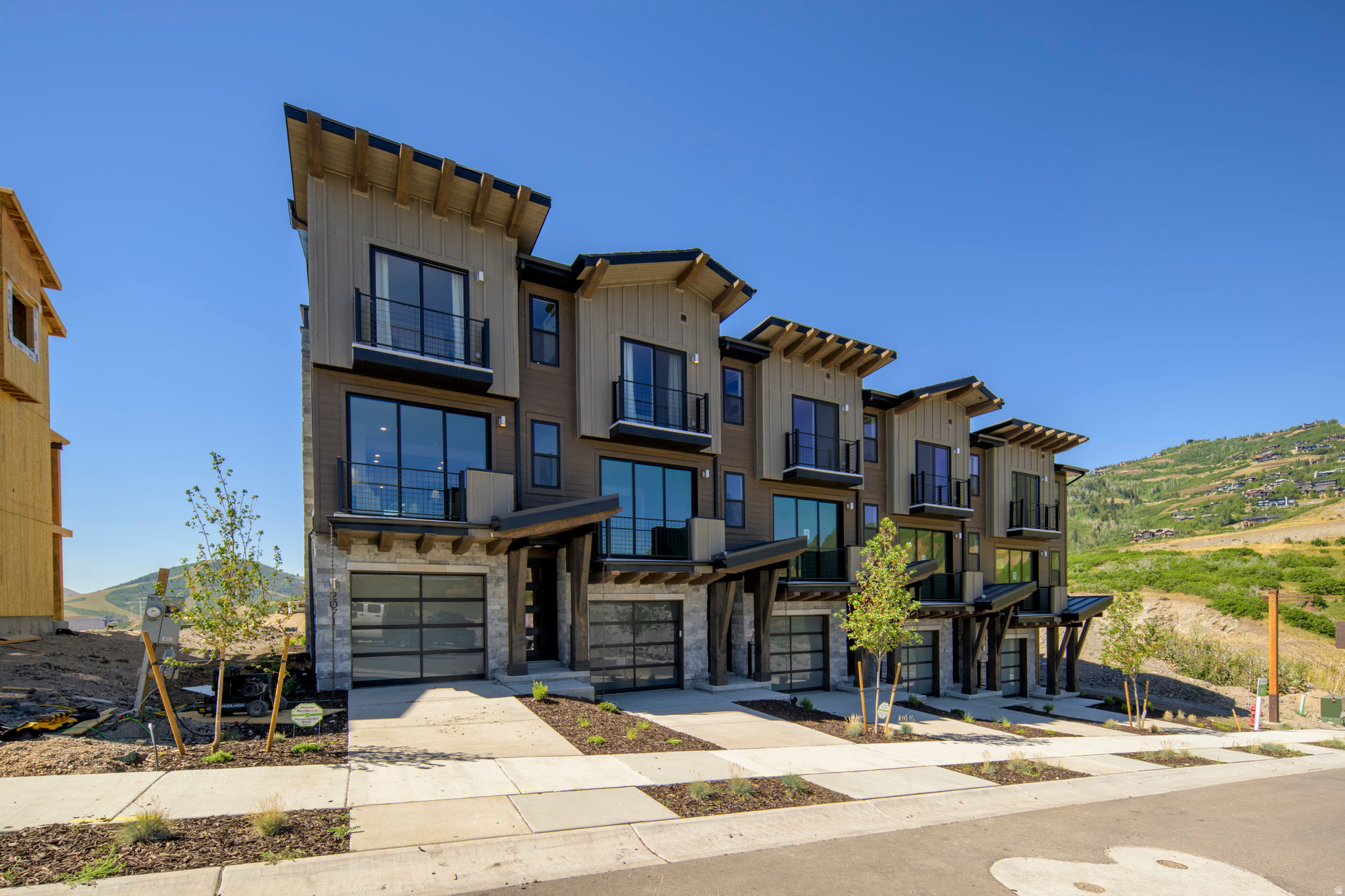 Welcome to The Pointe at Current-where modern design meets mountain resort living. Ideally located between Park City and Heber City along the scenic western shore of Jordanelle Reservoir, this exceptional townhome offers the perfect balance of luxury, adventure, and sustainability.  Surrounded by the breathtaking Wasatch Mountains, you'll enjoy effortless access to hiking and biking trails, world-class skiing and snowboarding, and endless water recreation at Jordanelle Lake-your year-round outdoor playground. A private underpass beneath SB450 provides convenient access directly to Deer Valley Resort, making mountain adventures easier than ever.  Built to Garbett Homes' Efficiency+ standards, this home prioritizes energy efficiency, comfort, and healthier living. Advanced insulation, Solar-E windows, and an energy-recirculation system help maintain ideal indoor temperatures while maximizing natural light and reducing utility costs.  Inside, you'll find beautiful quartz countertops, custom cabinetry, and durable high-performance flooring that bring both style and functionality to the space. Step onto your private balcony to take in the fresh mountain air, or unwind in the included private hot tub after a day of adventure. The home also features a built-in security system for added peace of mind.  Upstairs, two spacious primary suites provide comfort and privacy, including a stunning grand suite with its own private outdoor escape overlooking the surrounding natural landscape.  With no HOA restrictions on nightly rentals, this property offers incredible flexibility-whether you're seeking a mountain getaway, full-time residence, or investment opportunity.  Ask about available incentives when using our preferred lender!