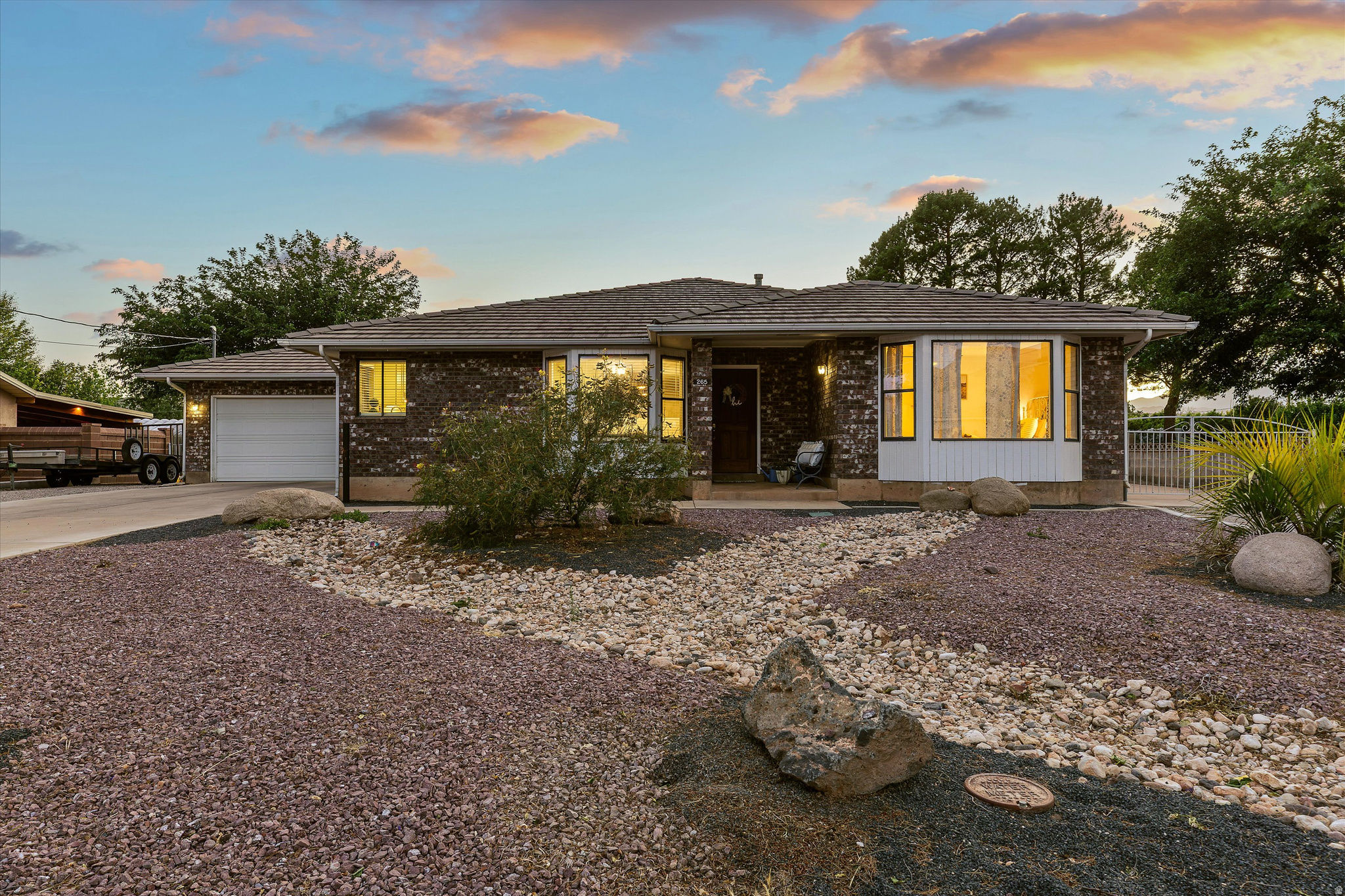 Charm meets opportunity in this thoughtfully updated 4-bedroom, 3-bath La Verkin home on a 0.4-acre lot with no HOA. Fresh paint, new finishes, and updated kitchen countertops blend seamlessly with cottage-style character - including a light-filled kitchen and a welcoming living room anchored by a wood-burning stove set into a classic brick mantle. The upstairs hosts a primary suite with an ensuite bath featuring a beautifully tiled stand-up shower, plus a second bedroom and a full bath. Downstairs, a spacious recreation room is joined by two additional bedrooms and a third bathroom (also with a stand-up shower) - flexible space for guests, hobbies, or a home office setup. A 2-car garage adds everyday convenience. Step outside to a backyard built for Southern Utah living: a covered patio for shaded evenings, a grass lawn for play, and a sizable open dirt area that's a true blank canvas. Add a pool, park your recreational toys, or explore options for a future ADU - the possibilities are wide open. 2,699 sq ft of move-in ready charm with room to make it your own.