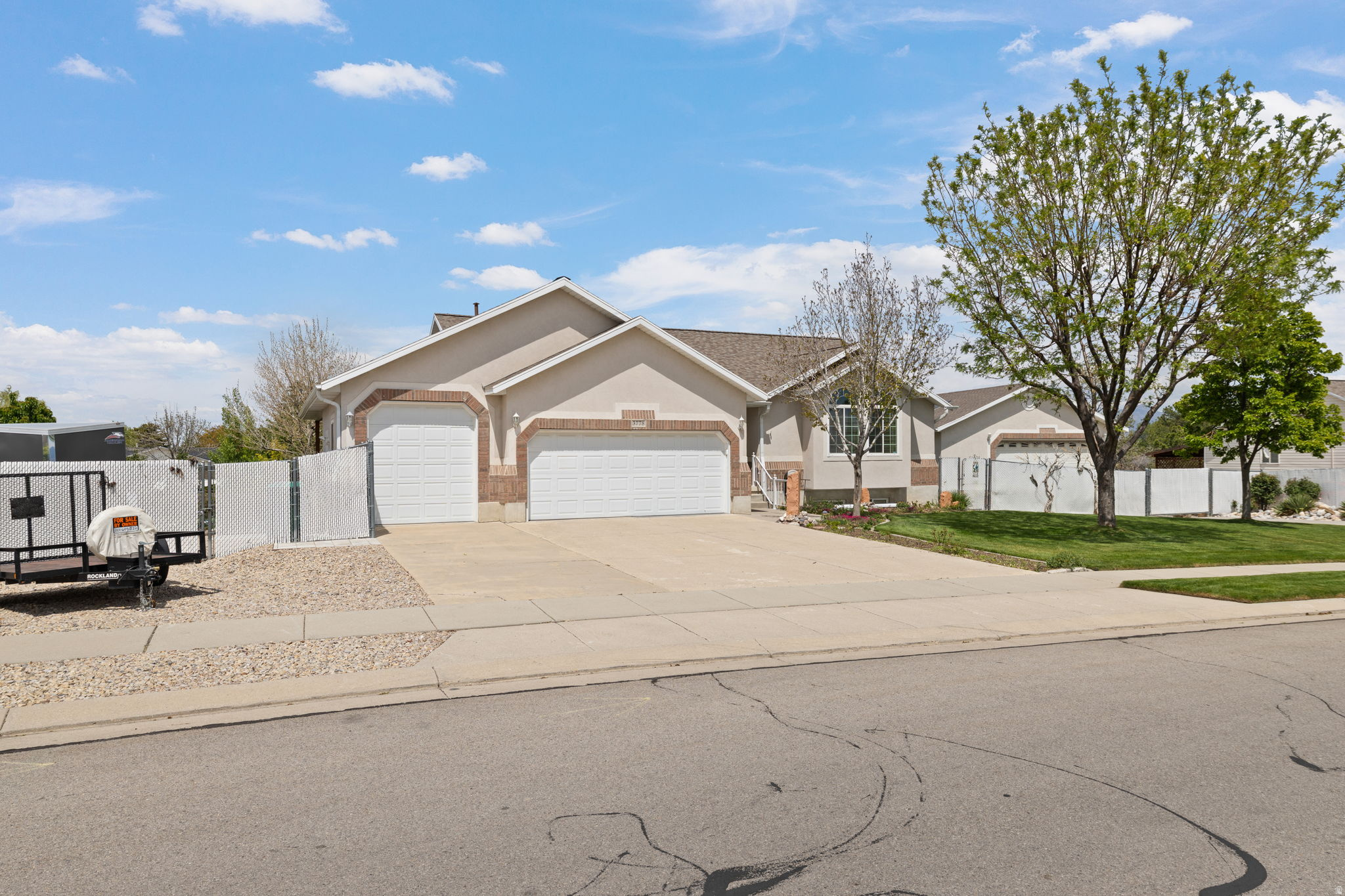 Searching for a home with the ultimate garage and workshop setup? Your search ends here. This impressive 30x40x14 detached shop features an oversized 12x18 garage door and space for at least four vehicles. Designed with functionality in mind, the shop includes both a wood stove and gas heater, full electrical and cable wiring, two 50-amp outlets, an enclosed airline system with air compressor, a private half bath, and easy access for larger vehicles and equipment. The home itself has been just as meticulously maintained. Owned by only one owner since it was built, pride of ownership is evident throughout. Inside, you'll find a full walk-out daylight basement featuring a fully self-sufficient apartment with separate laundry; ideal for multigenerational living, guests, or rental income potential to help offset your mortgage. The main level offers tall vaulted ceilings, abundant natural light, and a thoughtfully designed floor plan that combines comfort and functionality. Step outside to enjoy the beautifully manicured yard and custom water feature from the covered deck or included hot tub. Gardening enthusiasts will appreciate the dedicated garden space and greenhouse. Additional features include an attached 3-car garage with an extra-tall third bay and a 50-foot RV parking pad located on the west side of the home. Whether you're looking for comfort, workspace, storage, or income potential, this property offers exceptional versatility with no detail overlooked. Located just minutes from Jordan Landing for shopping and dining and with easy access to Bangerter highway, you also won't find yourself sacrificing location for all this!  Square footage figures are provided as a courtesy estimate only.  Buyer is advised to verify all information contained in listing.