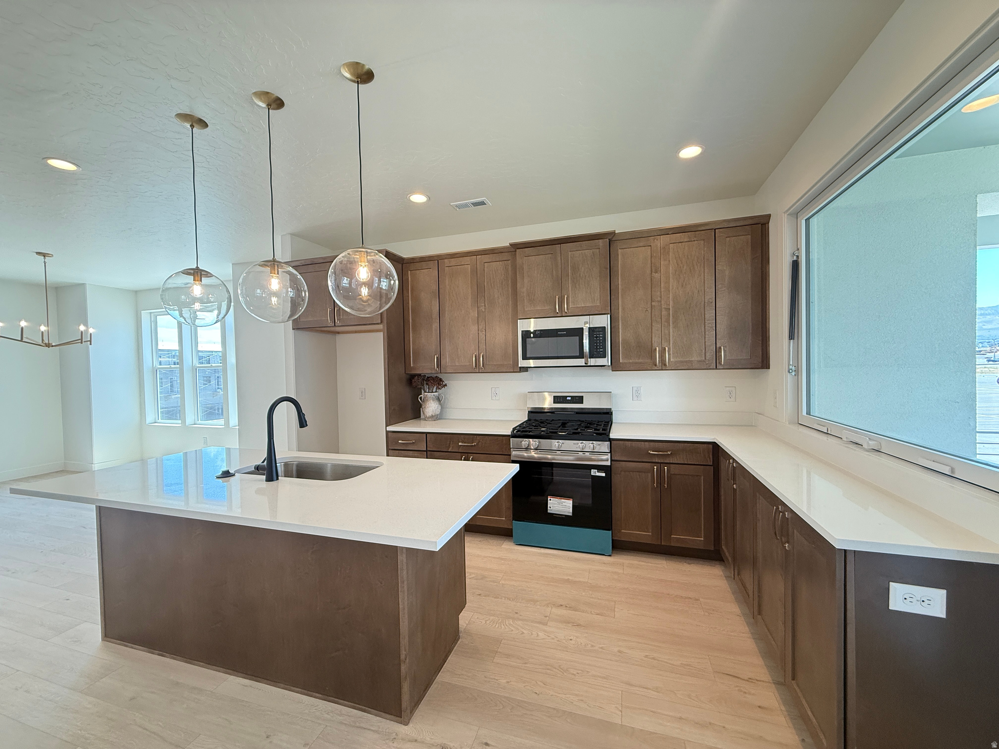 Our Beautiful Cabo Wabo Townhome Nestled in Downtown Daybreak Near Shopping, Dining, Parks, and Top-rated Schools. The Cabo Wabo redefines indoor-outdoor living with a standout design that blurs the line between inside and out. A unique vertical lifting window connects the kitchen directly to the deck, creating a seamless flow that transforms everyday moments into experiences. The open layout maximizes space and functionality, while multiple bedroom options and a two-car garage add versatility. Designed for both entertaining and everyday comfort, the Cabo Wabo is truly one of a kind. Home is ready for Quick Move In!