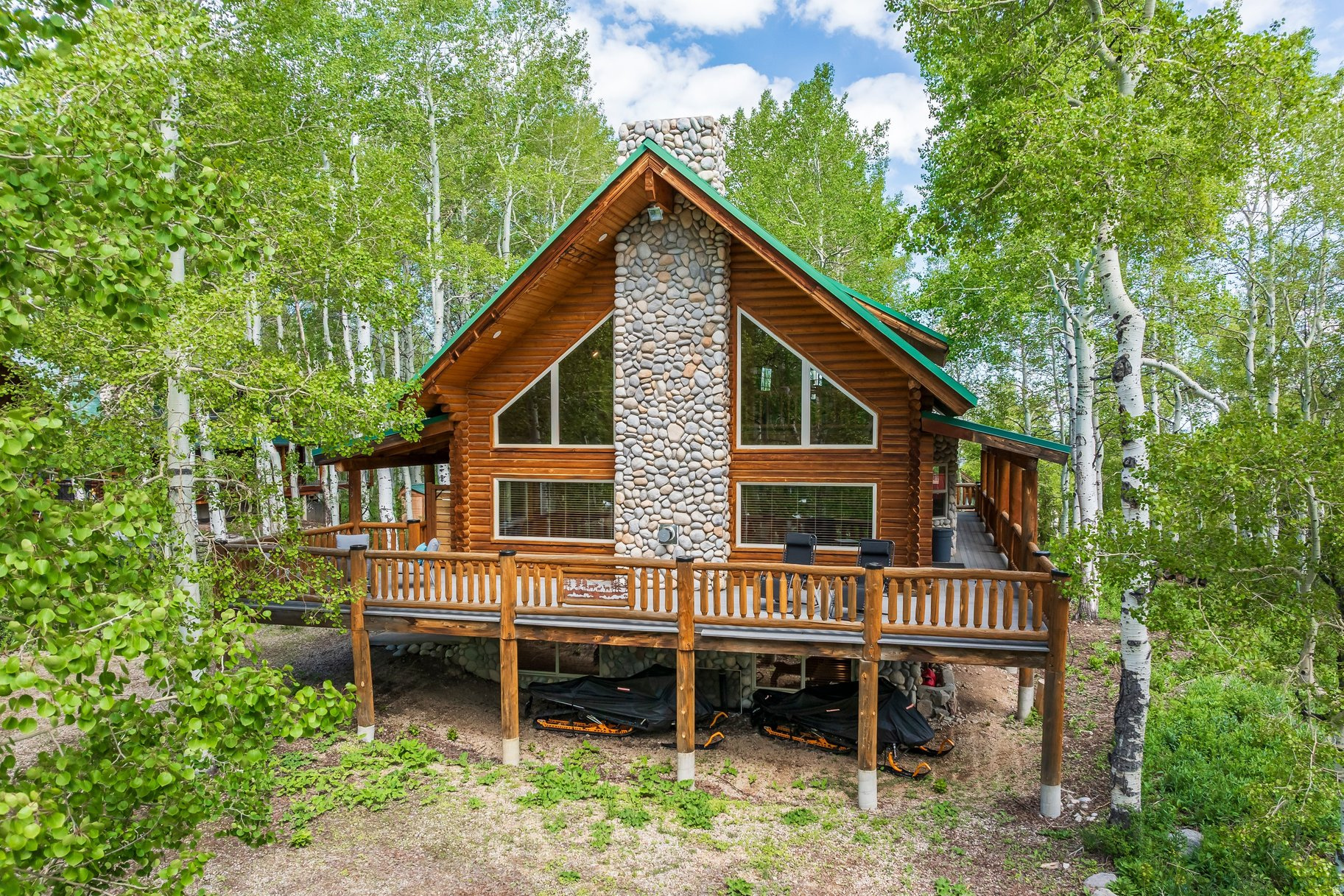 Tucked among a grove of mature aspens, this thoughtfully reimagined mountain retreat offers the rare combination of mountain living and modern comfort. Extensively remodeled with careful attention to quality and function, the home has been updated from top to bottom so everything works exactly as intended-allowing you to spend less time maintaining and more time enjoying the mountains. The great room is anchored by a soaring floor-to-ceiling stone fireplace, creating a warm and inviting gathering space beneath vaulted ceilings and expansive windows that bring the glorious outdoors in. Surrounded by aspens and natural beauty, the property provides convenient access to year-round outdoor recreation. In winter, drive in and snowmobile out to snowy adventures right from your doorstep. During warmer months, enjoy the serenity of the forest, abundant wildlife, and cool mountain air from expansive outdoor living spaces. Whether you are seeking a full-time residence, a weekend escape, or a legacy mountain home, this turnkey property delivers the best of mountain living: beautifully updated, meticulously maintained, and ready to enjoy from day one. Do not miss this treasure, make an appointment to see this property before it is gone!
