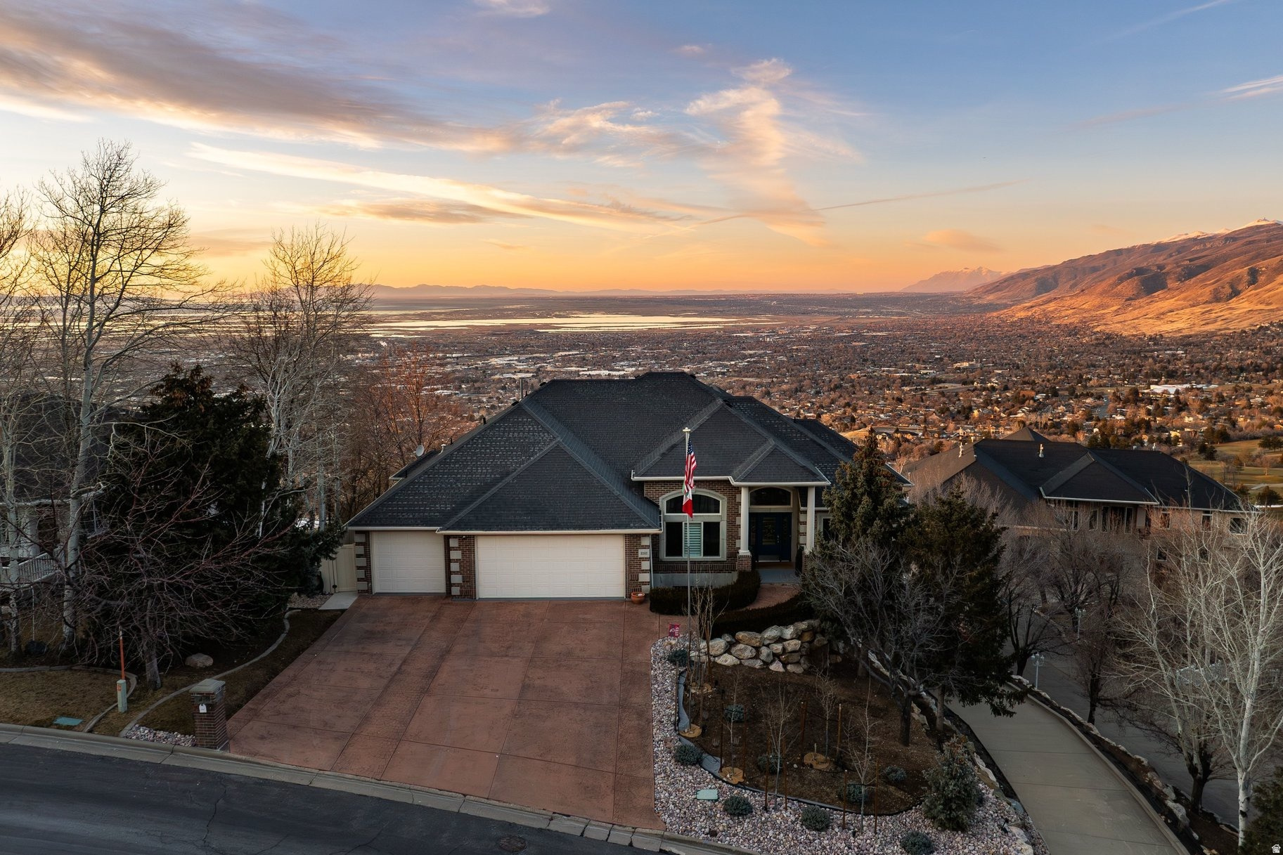 Welcome to Sunset Hollow. This grand and spacious home with one-of-a-kind sunset views, high on the east bench, is a MUST SEE. This fully brick, five-bedroom, four and a half bathroom home spans over 5900 sq ft with unobstructed views to the west. This home has ample storage and living space, a three car garage with electric car charging, and a heated home shop for any car or woodworking enthusiast. Sitting on over a half acre with mature landscaping and a fully fenced in backyard. An outdoor kitchen where you can enjoy the valley and lake views from the two tiered back porch. Make lasting memories with family and friends in this entertainer's dream home