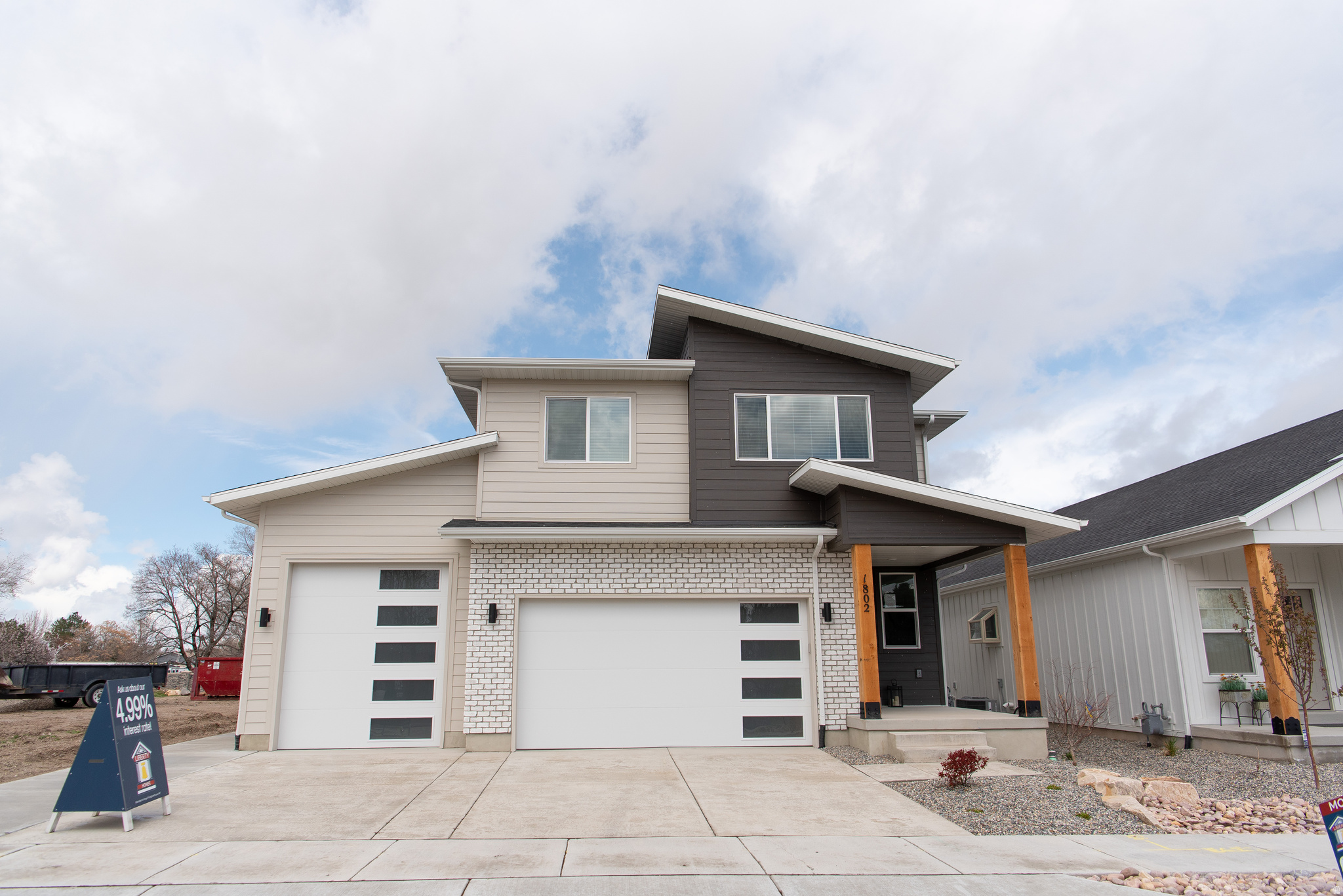 Last home in new sought after neighborhood! This has been our model home and now it is finally up for sale.  This home has upgrades galore with something for everyone.  This gorgeous modern 2 story has an oversize 3 car garage and separate walkout entrance. **Downstairs has a Full ADU in basement apartment with kitchen and laundry hookups. **Main level boasts a 2 story great room with linear modern fireplace, LVP flooring, huge pantry with costco door, upgraded cabinets with double crown, double trash, and soft close doors and drawers, half bath, thick edge 6 cm quartz tops, Black Stainless Steel double oven range & appliances. **Upstairs has vaulted ceilings, custom tile work in primary shower and bath with double sink, loft area for computer desk or play area, and 3 bedrooms and 2 baths. Beautiful area and accessible location. OWNER/AGENT.    Square footage figures are provided as a courtesy estimate only and were obtained from ______________ .  Buyer is advised to obtain an independent measurement.