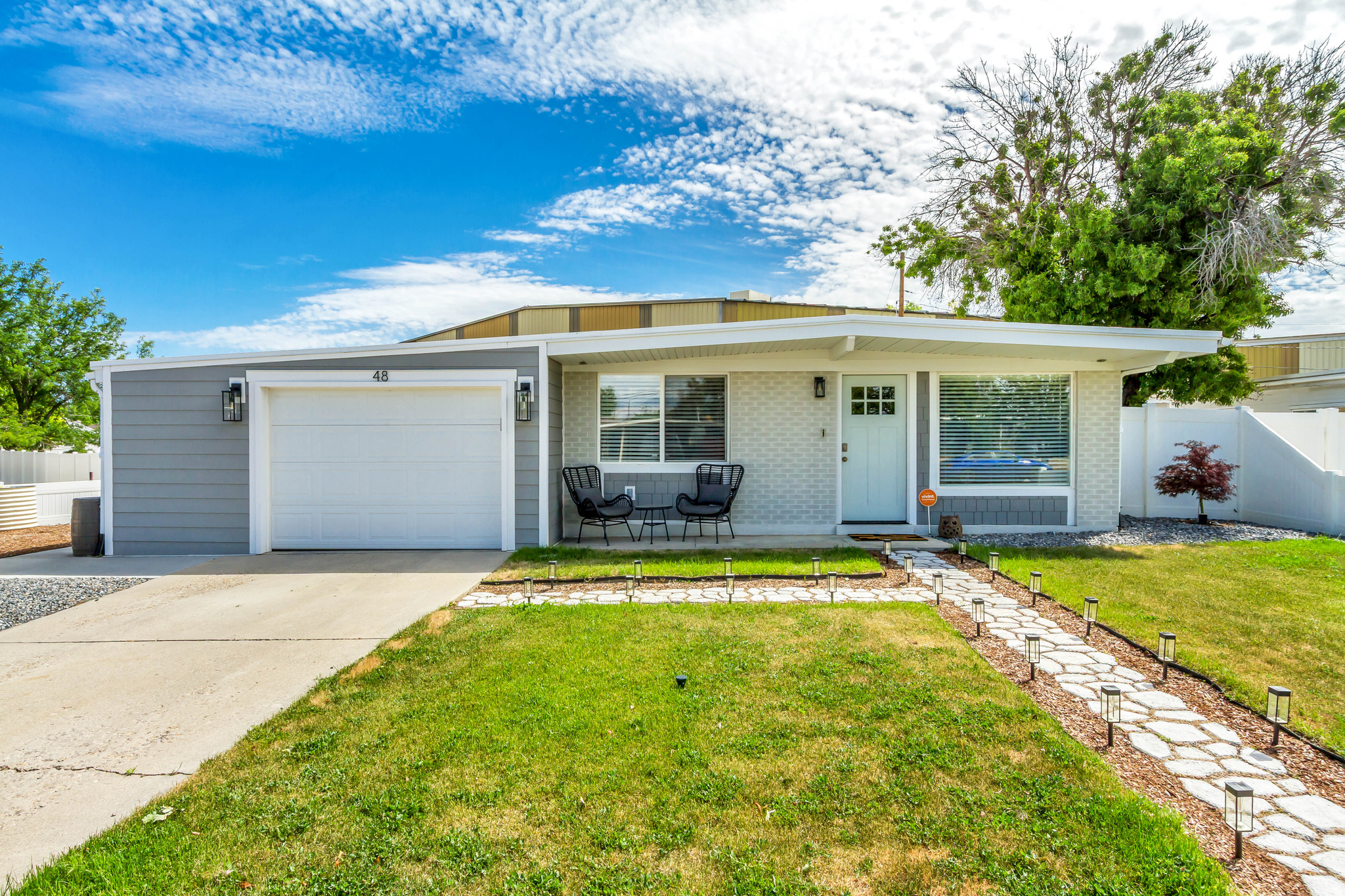 ** OPEN HOUSE SATURDAY 6/6 FROM 10AM-2PM ** A rare offering in the heart of Murray! This classic 1958 brick rambler was taken to the studs in 2019 and rebuilt with quality, modern systems and finishes. The plumbing, electrical, water main, water heater, HVAC system, roof, and appliances were all updated, pairing the character of an established neighborhood with the peace of mind of a modern build, all completed under permit and to code. Inside, the kitchen opens to the dining and living areas in a bright, connected single-level layout. It's finished with solid wood cabinetry, high-end quartz countertops, a tile backsplash, and quality hardware. Both bathrooms feature custom vanities with quartz tops, tiled floors, custom tile surrounds, thick frameless glass shower doors, and Moen fixtures. AquaGuard flooring runs through most of the home, with LED lighting throughout and ceiling fans in the bedrooms. Outside, updates include Hardie siding, fresh paint, soffit, fascia, and gutters, along with an automatic drip irrigation system, areas of low-maintenance rock landscaping, a white vinyl privacy fence, and raised garden beds plumbed into the drip system and ready for planting. Don't be fooled by the single-car look from the street: the garage opens into a surprisingly deep tandem space with extra width, leaving room for a second vehicle, a workshop, or generous storage. Smart-home features let you control the lights, sprinkler system, thermostat, garage door, and doorbell from your phone. The location is hard to beat, within walking distance of the popular Fashion Place Mall and just minutes from the I-15 and I-215 junction, making downtown Salt Lake City, the airport, and the ski resorts all more accessible than almost anywhere else in the valley. Top-tier workmanship and a move-in-ready feel in one of Murray's most convenient settings.
