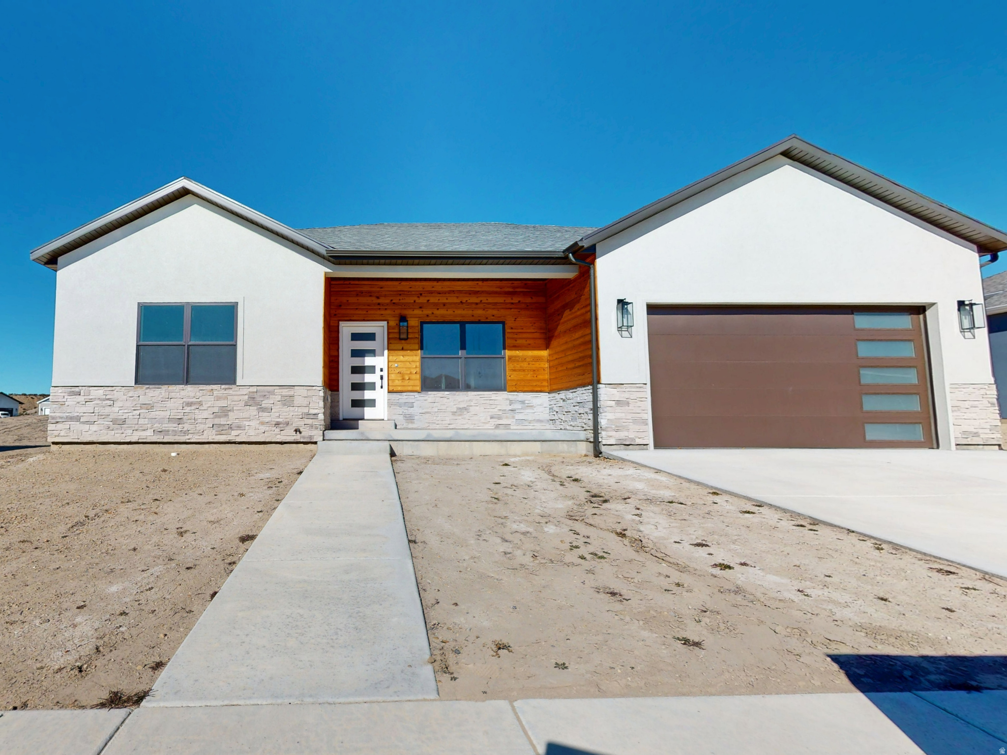 Introducing a modern new-construction home with three bedrooms and two bathrooms, designed with a contemporary style featuring dark accents and brushed nickel fixtures. This home offers a spacious basement and a two-car garage, providing plenty of storage and parking. Both bathrooms include double sinks, adding convenience and a touch of luxury. The chef's kitchen is equipped with all-new G.E. stainless steel appliances, Corian countertops, and a farmhouse sink. Thoughtful details include a pantry, closet organizers, and a dedicated cabinet for the kitchen wastebasket. The master bedroom and dining room both open to a charming back patio, perfect for outdoor entertaining or relaxation. Additional features include plumbing for a water softener and garage outlets ready for electric vehicle charging. With its combination of modern design, functionality, and eco-friendly elements, this home is the ideal choice for contemporary living.