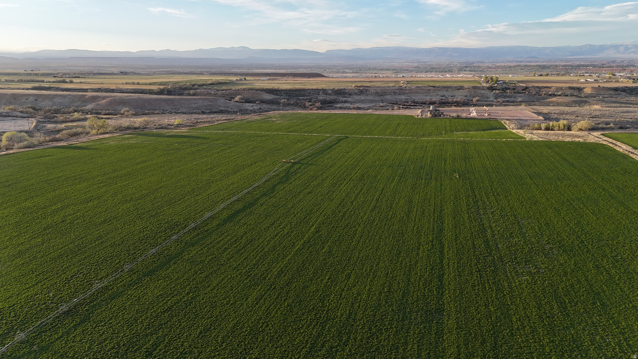 Outstanding mountain views, productive farm ground, and a rare Dry Gulch water package come together in this exceptional Basin property. Featuring 139.69 acres with approximately 58 irrigated acres, plus additional pasture and grazing ground, this property offers the functionality serious ag buyers need with the scenery, privacy buyers want, and room to expand irrigated acres. Improvements include retention ponds, corrals, and a private setting with room to operate. The sale includes 120 shares of Dry Gulch Irrigation Company Class C water shares, adding significant value and long-term utility. A singlewide home with utilities connected is included and will be sold as-is (value is in the land), providing immediate use for housing, rental potential, or a future homesite. Included in the sale is Parcel 00-0028-1505 and Parcel 00-0007-2227, creating a unique opportunity for productive farm use, livestock operation, expansion, or long-term investment in one of the Uintah Basin's most desirable rural settings. The farm ground is currently being lease. buyer will need to honor the lease until it expires. Buyer to verify all information and do their own due diligence.