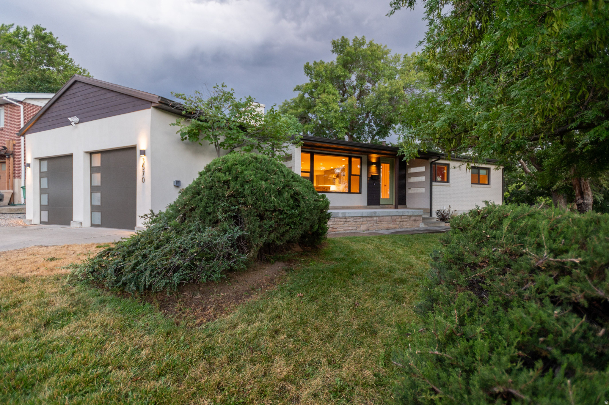Tucked into Olympus Cove on two combined parcels totaling .32 acres, this fully remodeled 4-bedroom, 3-bath rambler pairs mountain views with a location that puts everything within easy reach. Downtown Salt Lake, the airport, and Park City's Kimball Junction are all a short drive away, and mountain biking and hiking trailhead access starts right down the street, a rare combination of privacy and proximity.  The 2018 remodel touched every inch of the home: quartz counters, white oak hardwood floors, LG appliances, and a 6-burner Wolf range anchor the kitchen. The great room's fireplace and formal dining area open onto a front patio built for watching the sunset over the valley. The primary suite includes a walk-in closet and ensuite bath, also with mountain views.  Downstairs, a fully finished basement adds two more bedrooms, a full bath, a living room with dry bar and beverage fridge, and a separate glass-door entrance that opens straight to the side yard. Out back, mature trees, a full concrete patio, and a fenced, gated yard create a private space to entertain or unwind, with mountain views all to yourself.  The .32-acre lot (two parcels: .19 and .13 acres) offers real development flexibility, and a 2-car garage with attic storage covers gear for every season. High-efficiency furnace, AC, windows, smart lighting, and a whole-home humidifier round out the mechanicals. Location, views, remodel quality, and trail access at your doorstep: this one is hard to replicate.
