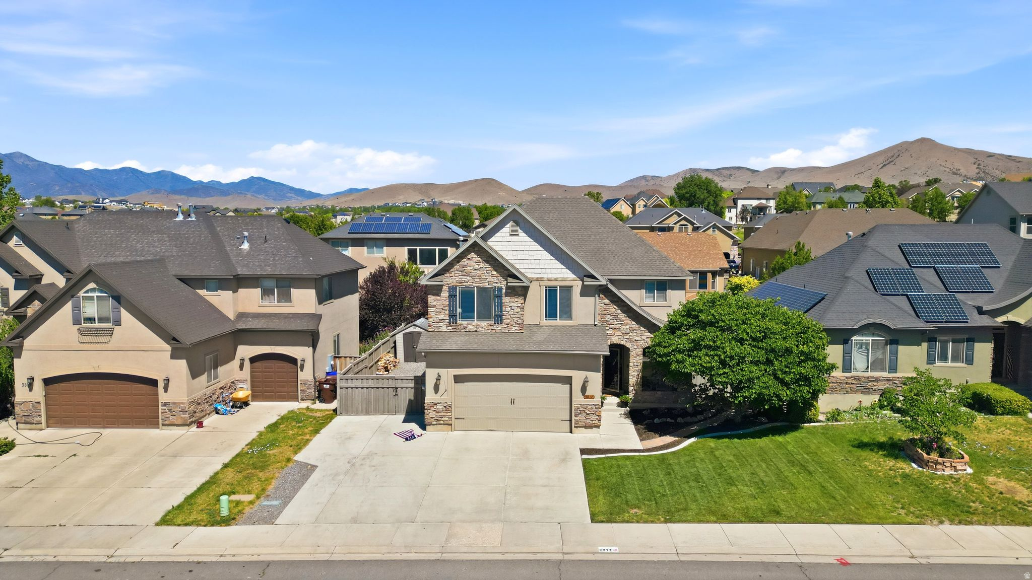 Ideally situated near the golf course and surrounded by beautiful mountain views, this spacious home offers the perfect blend of comfort and convenience. The bright, open floor plan features a modern white kitchen with an oversized island, abundant cabinetry, and seamless flow into the dining and living areas, making it ideal for everyday living and entertaining. The generous primary suite includes a beautifully updated spa-inspired bathroom with a freestanding soaking tub, walk-in shower, and large closet. Downstairs, the finished basement provides a second family room and additional living space for guests, recreation, or movie nights. Outside, enjoy the covered patio and fully fenced backyard with plenty of room to relax, play, or create your dream outdoor retreat.