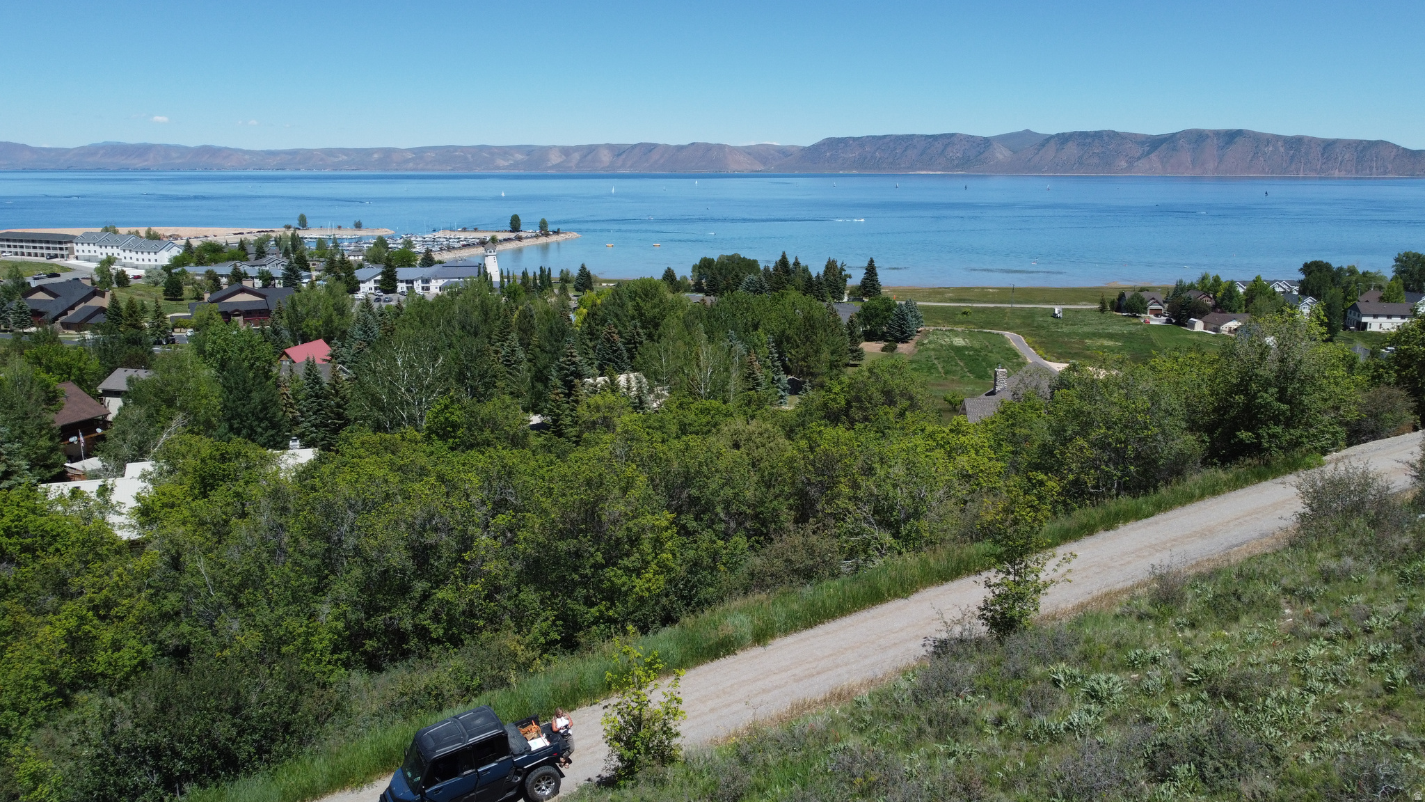 0.34-acre sloped building lot with stunning, unobstructed lake views, located within walking distance of the Start Park Marina. Situated in the highly sought-after Harbor Village neighborhood, this property offers year-round access and a quiet culdesac street. Enjoy hundreds of miles of groomed snowmobile trails, along with hiking and SxS trails, perfect for long summer days by the lake. Come build your Bear Lake Getaway today.