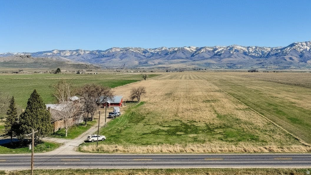 Picturesque flat lot in rural Fairview area with mountain views all around. With exceptional soil quality and pressurized irrigation it is a great spot for your hobby farm and homesite. With easy access to town and close to Utah.  Large parcel to build on and still have plenty of room for animals.  PERC test and survey have been done and will be provided.  Buyer will need to drill a well.  8 water shares of Cub River Irrigation come with the acreage and is on a private pressurized line. Address is approximately 5300 S State Street, Preston-.  ID land map is available on tour tab function.