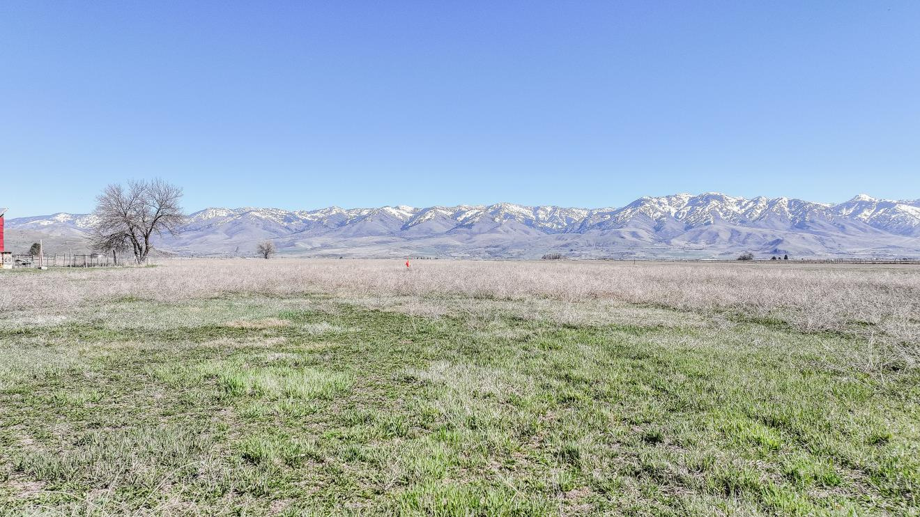 Picturesque flat lot in rural Fairview area with mountain views all around. With exceptional soil quality and pressurized irrigation it is a great spot for your hobby farm and homesite. With easy access to town and close to Utah.  Large parcel to build on and still have plenty of room for animals.  PERC test and survey have been done and will be provided.  Buyer will need to drill a well.  8 water shares of Cub River Irrigation come with the acreage and is on a private pressurized line. Address is approximately 5300 S State Street, Preston-.  ID land map is available on tour tab function.