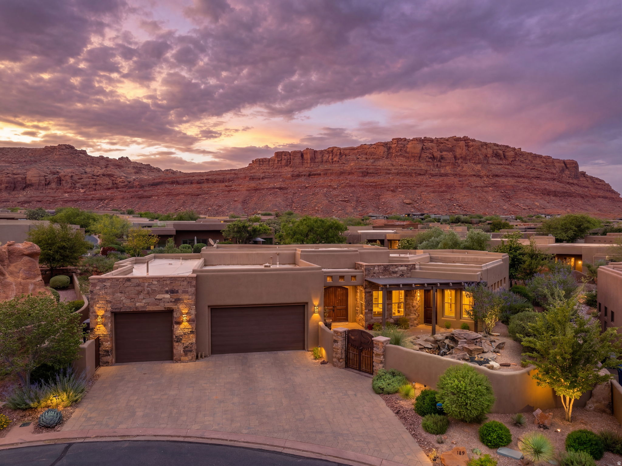 Situated within the exclusive The Cliffs of Snow Canyon community, this stunning 3,740 sq. ft. residence offers a perfect blend of luxury, comfort, and breathtaking Southern Utah beauty. Featuring 4 bedrooms, 3.5 baths, a dedicated office, private casita, and thoughtfully designed living spaces throughout, this home is crafted for both elegant entertaining and everyday enjoyment. Expansive windows capture spectacular red rock views and fill the home with natural light, creating a seamless connection between the indoors and the stunning desert landscape. The open concept floor plan flows effortlessly from the gourmet kitchen to the spacious living and dining areas, providing an inviting setting for gatherings with family and friends. A custom built bunk room creates a fun and memorable retreat for guests, while the private office offers a quiet space for work or personal pursuits. The detached casita provides additional privacy and flexibility, making it ideal for visitors, extended family, or a luxurious guest suite. One of the home's standout features is the beautifully designed front courtyard, complete with a tranquil water feature and inviting fire pit. This private outdoor space creates the perfect setting for relaxing evenings, morning coffee, or entertaining guests while enjoying the peaceful ambiance and surrounding desert beauty. The backyard is equally impressive, offering a private resort style oasis with a sparkling pool, built in barbecue, and multiple outdoor living spaces designed for year round enjoyment. Whether hosting unforgettable gatherings or unwinding beneath the Southern Utah sky, you'll appreciate the privacy, tranquility, and incredible red rock views that frame the property. Complete with a spacious 3 car garage and located in one of Southern Utah's most sought after communities, this exceptional home offers the ultimate desert lifestyle in The Cliffs of Snow Canyon where luxury, privacy, and spectacular scenery come together.