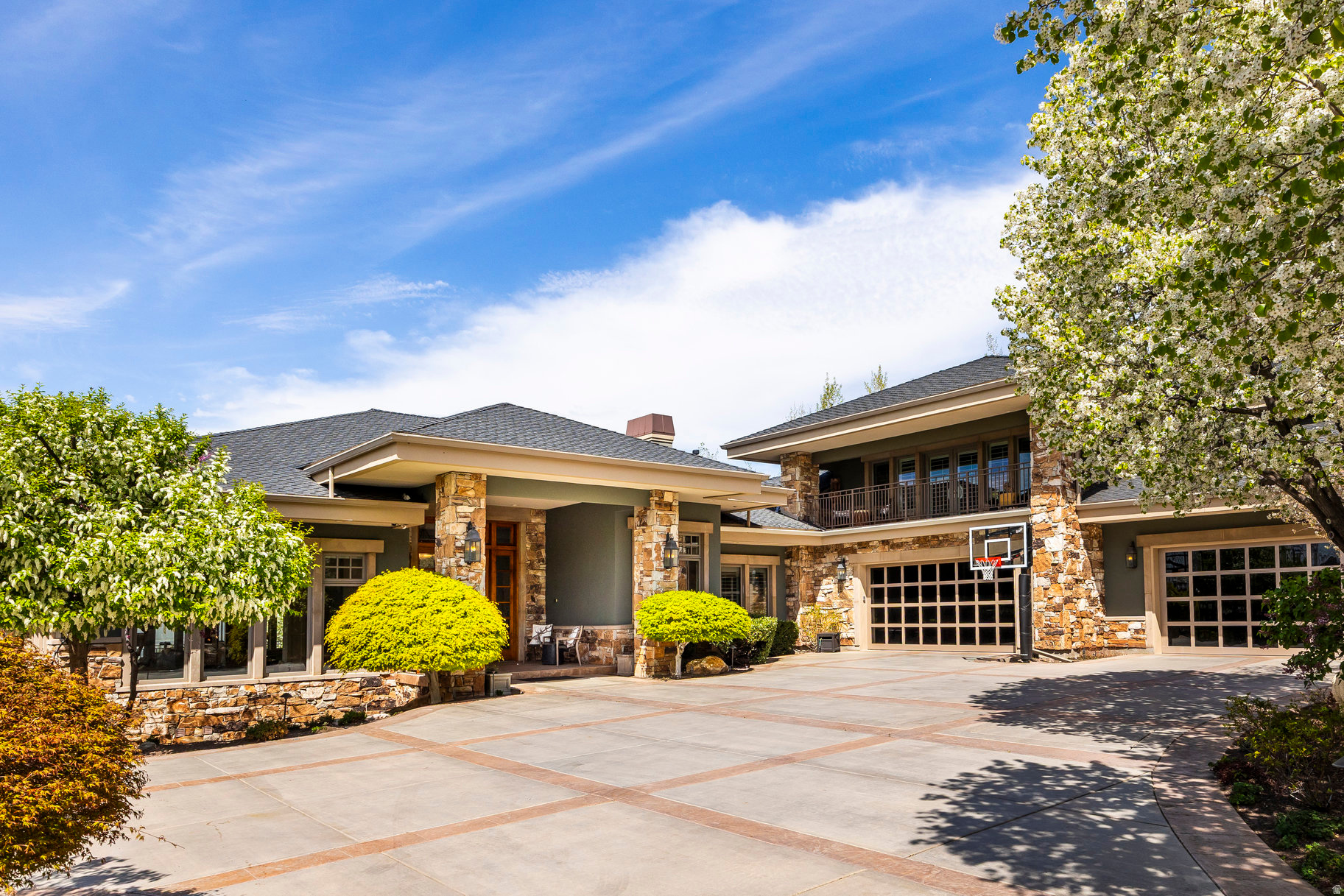 Perched on an exceptionally rare East Bench property this estate offers sweeping, unobstructed views across the entire Salt Lake Valley. The Contemporary Craftsman blends the warmth of a family retreat with the stature of a true legacy property. Set high on the East Bench foothills in a serene, park-like setting, the home offers remarkable privacy while remaining minutes from freeways, the University of Utah, downtown, and nearby ski resorts.  A gated, tree-lined drive leads to a residence defined by timeless craftsmanship-rich inlaid wood floors, soaring ceilings, refined moldings, and walls of windows that flood the home with natural light. Thoughtfully designed spaces invite both formal and casual gatherings, anchored by a spectacular double-island kitchen that serves as the heart of the home.  The lower level, a full walkout, offers expansive living and entertaining spaces: a theater, secondary kitchen, family and dining areas, a second laundry room, and abundant storage. The home features 6 ensuite bedrooms and 8 total baths, including a luxurious primary suite and a private upstairs guest quarters complete with full kitchen and a balcony facing Mt. Olympus.  Wraparound covered decks on both levels frame mesmerizing sunsets, sparkling city lights, and panoramic views in every direction. The outdoor spaces include a resort-style pool, separate hot tub, and mature landscaping designed for year-round enjoyment.  This property is a rare opportunity to own one of the most distinguished homes in the Salt Lake Valley-where unmatched views and exceptional design come together in perfect harmony.