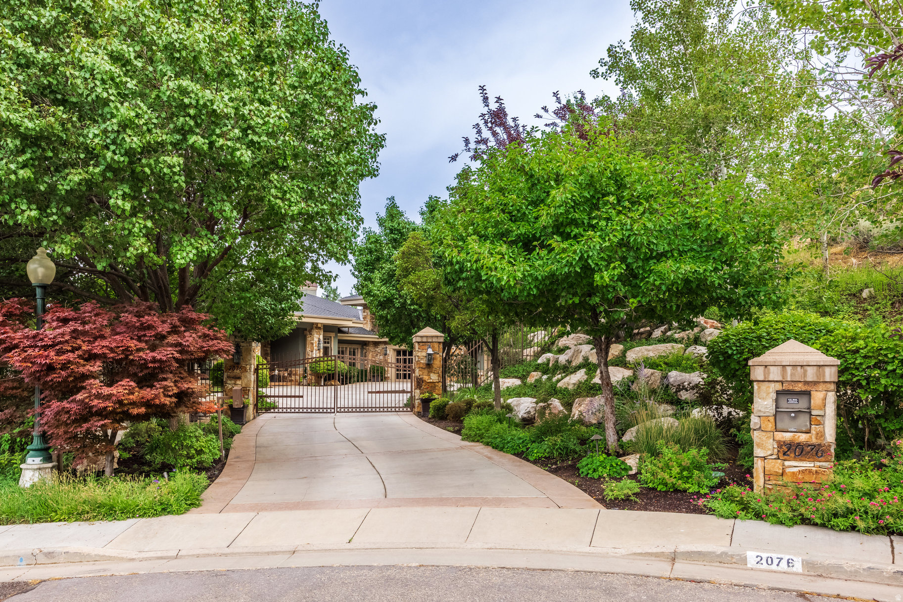 Perched on an exceptionally rare East Bench property this estate offers sweeping, unobstructed views across the entire Salt Lake Valley. The Contemporary Craftsman blends the warmth of a family retreat with the stature of a true legacy property. Set high on the East Bench foothills in a serene, park-like setting, the home offers remarkable privacy while remaining minutes from freeways, the University of Utah, downtown, and nearby ski resorts.  A gated, tree-lined drive leads to a residence defined by timeless craftsmanship-rich inlaid wood floors, soaring ceilings, refined moldings, and walls of windows that flood the home with natural light. Thoughtfully designed spaces invite both formal and casual gatherings, anchored by a spectacular double-island kitchen that serves as the heart of the home.  The lower level, a full walkout, offers expansive living and entertaining spaces: a theater, secondary kitchen, family and dining areas, a second laundry room, and abundant storage. The home features 6 ensuite bedrooms and 8 total baths, including a luxurious primary suite and a private upstairs guest quarters complete with full kitchen and a balcony facing Mt. Olympus.  Wraparound covered decks on both levels frame mesmerizing sunsets, sparkling city lights, and panoramic views in every direction. The outdoor spaces include a resort-style pool, separate hot tub, and mature landscaping designed for year-round enjoyment.  This property is a rare opportunity to own one of the most distinguished homes in the Salt Lake Valley-where unmatched views and exceptional design come together in perfect harmony.