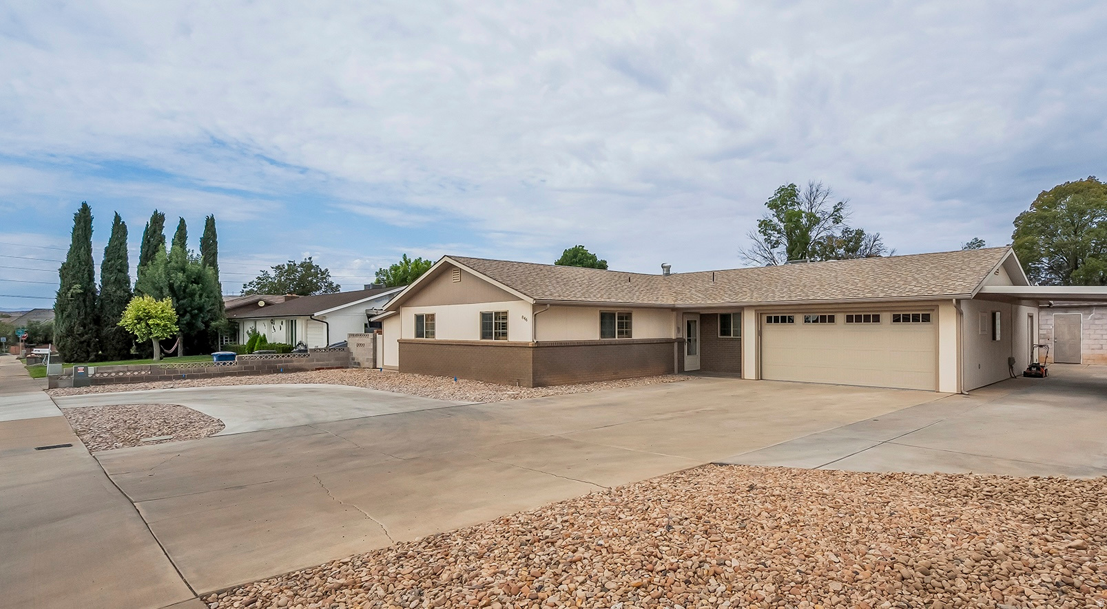 Classic St. George charm meets modern updates in this beautifully refreshed 4-bedroom + den, 2.5-bath home, ideally located just minutes from the university, hospital, shopping, and everyday conveniences. Inside, you'll find fresh paint, new carpet, a spacious kitchen with a large island, new Bosch appliances (refrigerator included), and convenient roll-out wire shelving. The remodeled primary suite features a stunning primary bathroom, and two large walk-in closets. Bedroom 4 and the den each offer private exterior entrances, creating flexible space for guests or a home office. Thoughtful upgrades continue throughout with plantation shutters, a skylight that brightens the kitchen and dining area, double-pane windows (new in 2005), and a private pet entrance. The finished garage is climate-controlled with central air and includes epoxy flooring, a new oversized 17' garage door with 100,000-cycle springs, and a smartphone garage door opener. Outside, enjoy a fully fenced yard, circular driveway, abundant parking, two-car garage, carport, RV parking, automatic sprinklers (in back), drip irrigation (in front) for future trees or shrubs, and a detached workshop complete with power and lighting. Exceptionally well-insulated, this home offers comfort, efficiency, and timeless appeal in one of St. George's most convenient locations.
