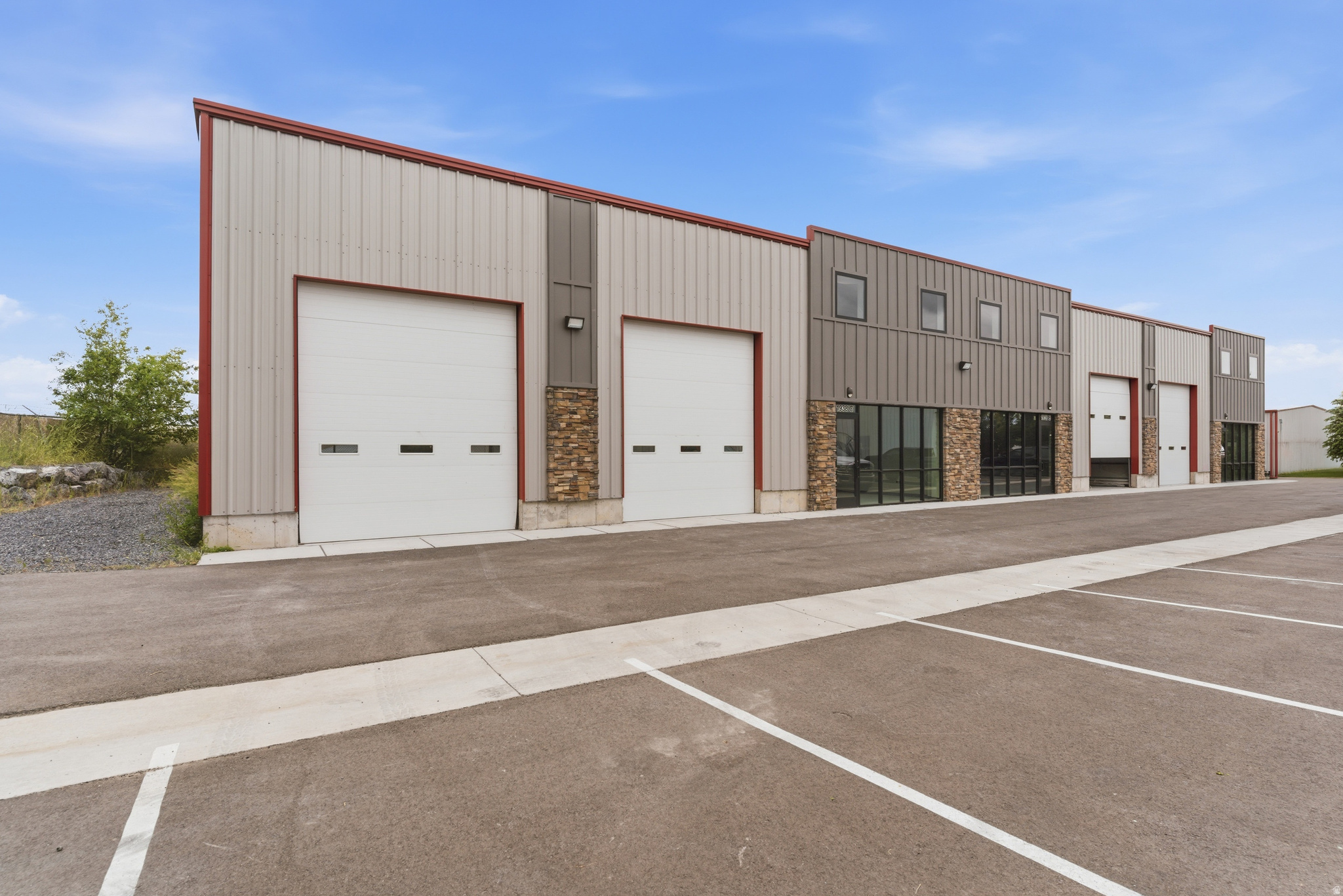 New Construction Roy Warehouse Ready for Tenant Improvements. 5,000 SF available space features 4,340 SF warehouse with three 14' x 12' overhead doors, 18' ceiling clearance, and 3-Phase power; 660 SF open office space with floor to ceiling windows; and possible additional 660 SF mezzanine. High ceilings and storefront windows provide lots of natural light throughout. Conveniently located just off busy 1900 West near Ogden Industrial Park, West Haven Industrial Park, and Ogden-Hinckley Regional Airport. Quick and easy access to freeway & major roads. Zoned Roy City Manufacturing. Space can be divided  call agent for details.