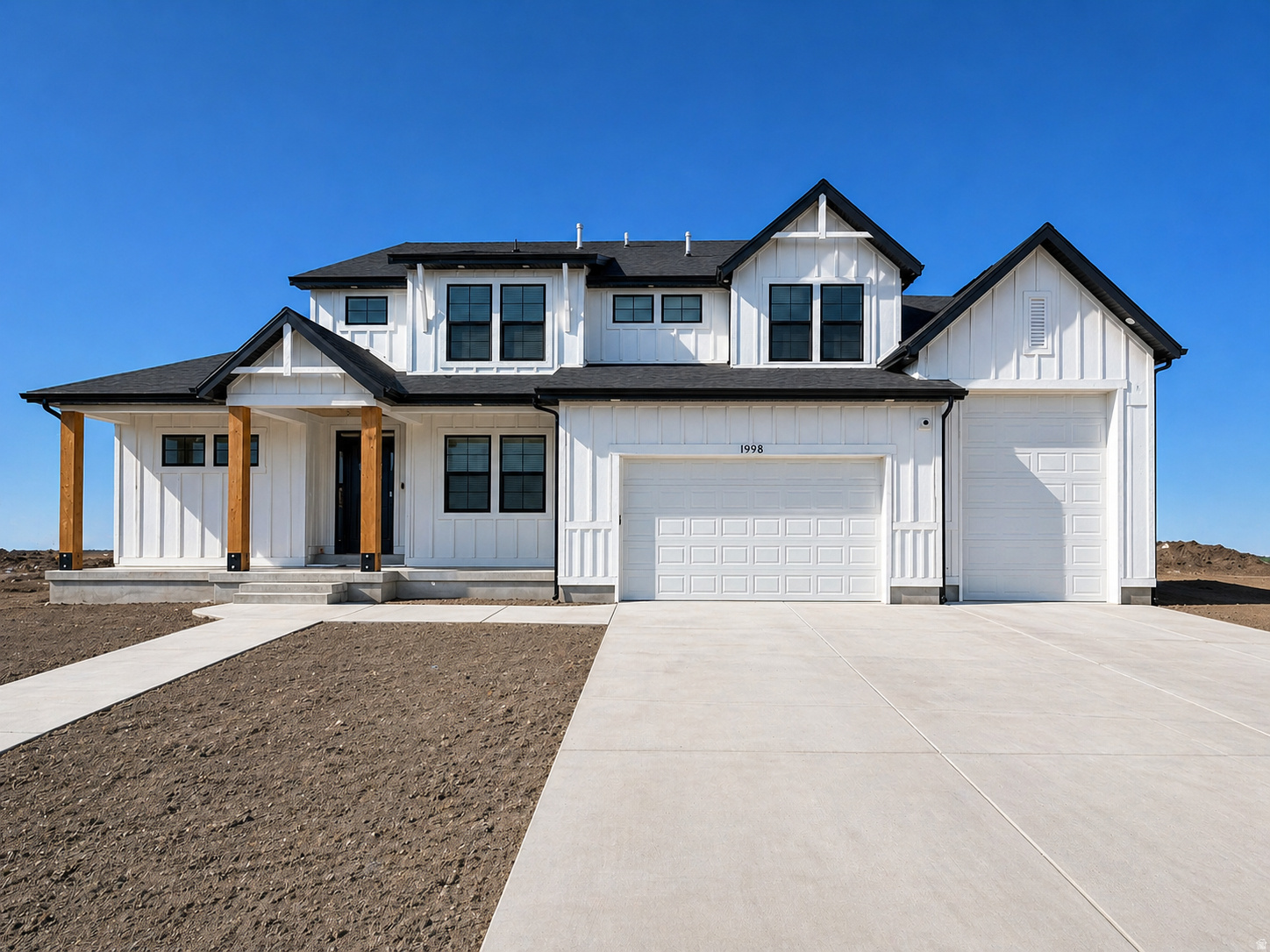 This to-be-built modern farmhouse in Eagle Haven Subdivision offers a rare chance to own new construction on a 0.44-acre south-facing lot with mountain views. At 5,500 sq ft, the plan includes 8 bedrooms, 6 bathrooms, and a fully finished basement across three levels. The exterior features white board-and-batten siding, cedar porch posts, and a 3-car garage. Inside, the main level delivers an open great room with two-story ceilings and a kitchen with a large island. The primary suite includes a tray ceiling and a generous walk-in closet with built-in shelving and dressers. The fully finished 1,900 sq ft basement adds meaningful living space for guests or extended family. This lot has a view of the future site of the announced Spanish Fork Utah Temple.