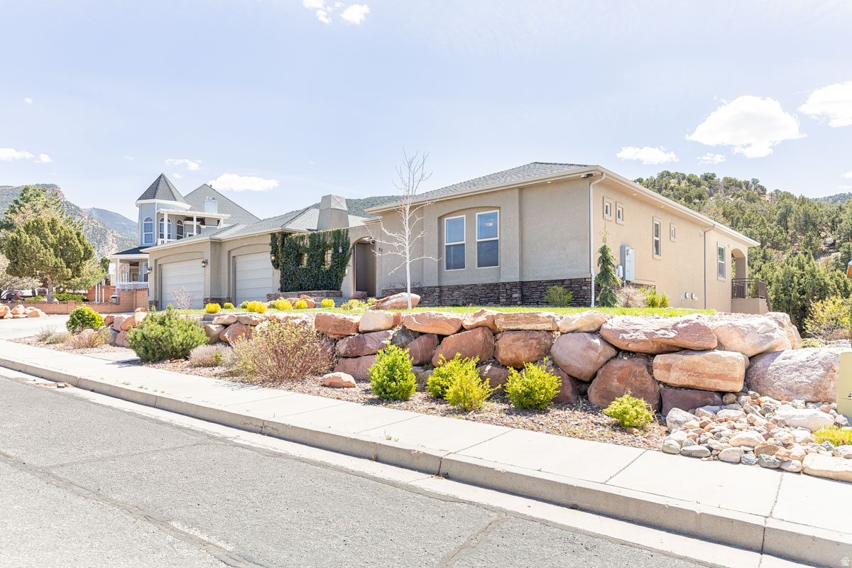 Luxury living in the heart of Fiddlers Canyon. This exceptional custom estate offers 6,488 sq ft on a beautifully landscaped 0.64-acre lot, blending quality construction, thoughtful design, and elevated comfort. The home features 5 bedrooms, 4.5 bathrooms, a gourmet kitchen with commercial-grade appliances, and expansive living spaces designed for both everyday living, and entertaining. The main-level primary suite includes a private sitting area, spa-style bath with steam shower and jetted tub, and direct access to the laundry. The fully finished walkout basement provides additional living space, a theater room, wet bar, and private guest accommodations with separate access-ideal for multi-generational living or extended stays. Built with enhanced insulation, three HVAC systems, and soundboard construction for comfort and efficiency. Additional features include a heated 4-car garage with epoxy floors and 220 power, detached shop, RV parking, central vacuum, reverse osmosis system, whole-home audio, electronic lighting controls, and security system. Outdoor living includes a private enclosed courtyard with fireplace, covered patio and deck, and mature landscaping designed for year-round enjoyment. Located in one of Cedar City's most desirable areas, with convenient access to trails, and outdoor recreation.