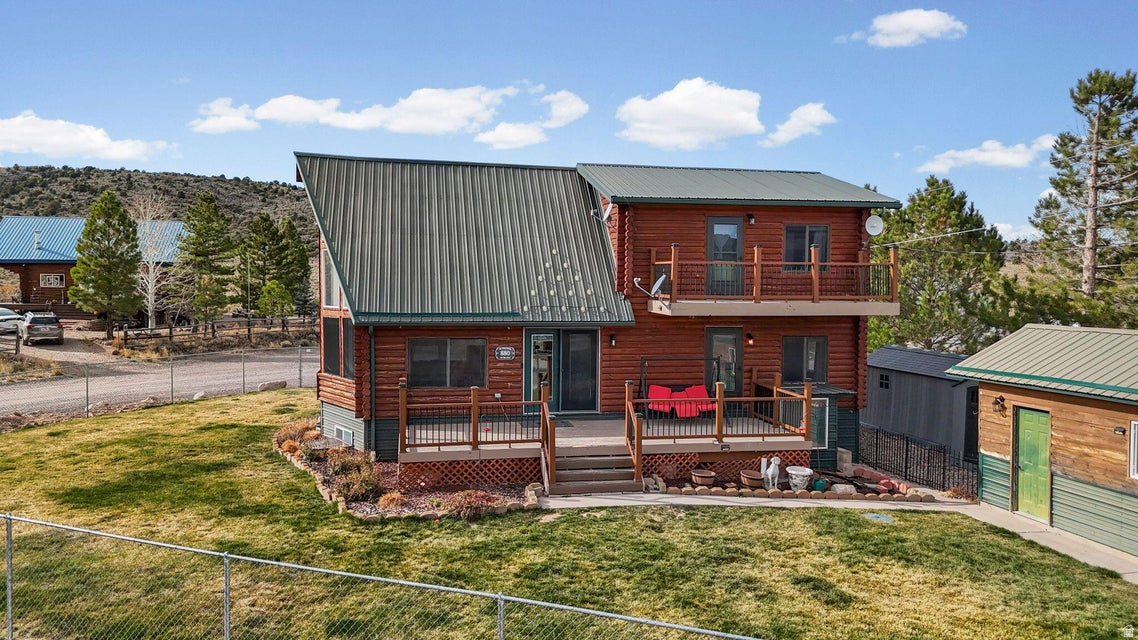 Two kitchens and a walk-out basement make this stunning A-frame log cabin as functional as it is beautiful! Completed in 2001, this 2,600+ sq.ft. retreat offers a spacious main-floor master suite, open living area with vaulted ceilings, and large windows showcasing mountain views. The upper loft features a private balcony, while the wraparound deck is perfect for relaxing or entertaining. Detached 1-car garage, storage shed, and plenty of parking. Whether you're looking for a full-time mountain home or a weekend escape, this Pine Valley gem delivers comfort, charm, and unbeatable scenery year-round