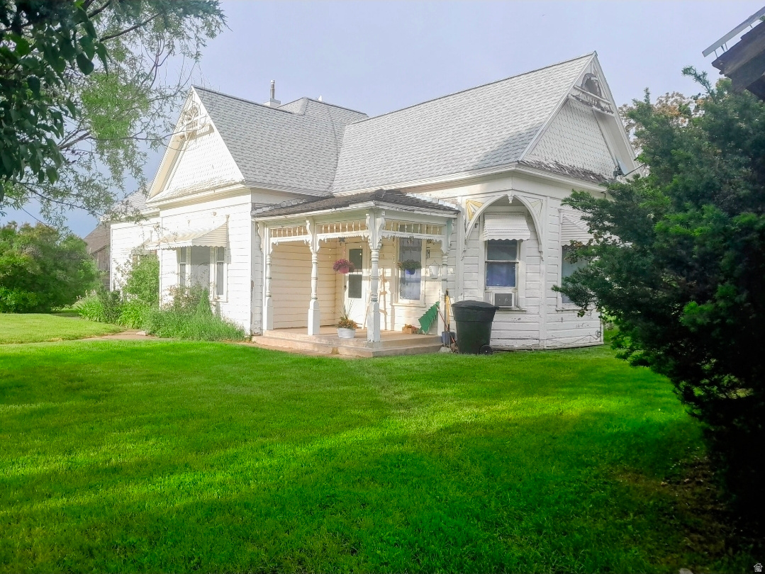 Bring the animals to this adorable Victorian home in Lewiston. With a full acre of land and a huge barn you'll have plenty of room for sheep, goats, chickens, and maybe a horse or cow too.  The home has amazing charm with it's high ceilings and beautiful original wood work. There are cosmetic projects for you, but the major things are already done. Roof was replaced in 2024, new wiring in 2022, main water line replaced in 2023 and the furnace is only 6 years old. The mountain views and surrounding farm fields might make you feel like it's in the middle of nowhere, but it's only 20 minutes from Logan.