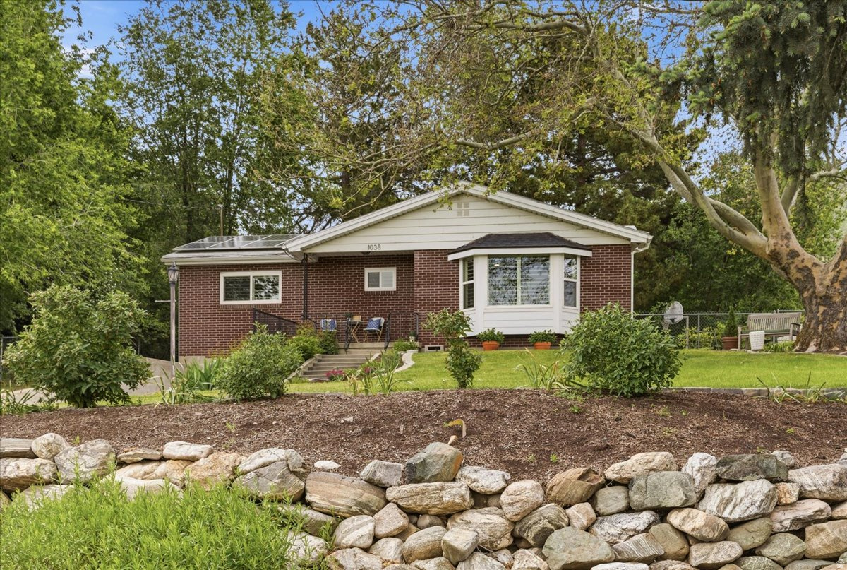 Located on Farmington's east bench, this remodeled red brick rambler combines classic construction with extensive modern upgrades and exceptional efficiency. Offering 5 bedrooms and 2 bathrooms, the home features a fully updated interior including remodeled kitchen and bathrooms, updated flooring, doors, paint, lighting, and more.  Major system improvements provide long-term peace of mind, including a new Lennox HVAC system, insulated garage door, main water line replacement (2025), sewer liner (2025), new gutters with heat tape cables (2025), secondary water connection (2025), and new dishwasher. The fully owned ~$25,000 solar system powers the all-electric home with utility costs of just $12.90 per month.  Additional features include aluminum roofing, plantation shutters, deep garage, oversized driveway with parking for 4+ vehicles, and a secluded fenced backyard with mature landscaping and western valley views.  Conveniently located near Farmington Canyon, Farmington Pond, Lagoon Trail System, Station Park, FrontRunner, and quick I-15 access for an easy commute to Salt Lake City.