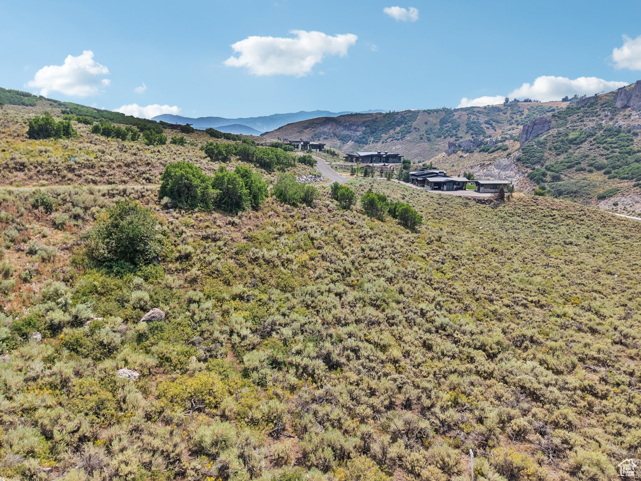 Enjoy panoramic views of rugged rock cliffs in Northgate Canyon, as well as open space, mature gamble oak, and the local resort peaks. This 1.25-acre lot has a gently sloped terrain and utilities at the street- ready for you to build your dream mountain retreat in stunning natural surroundings.  While additional amenities available by acquiring a Club Membership, all residents enjoy the community's extensive private trail network, scenic surroundings, and proximity to Park City's world-class skiing, dining, and entertainment. Hop on I-80 for a short drive to Salt Lake City International Airport.  Whether you're seeking peace, views, or a prime location for your future home, this lot offers exceptional value and lifestyle potential!