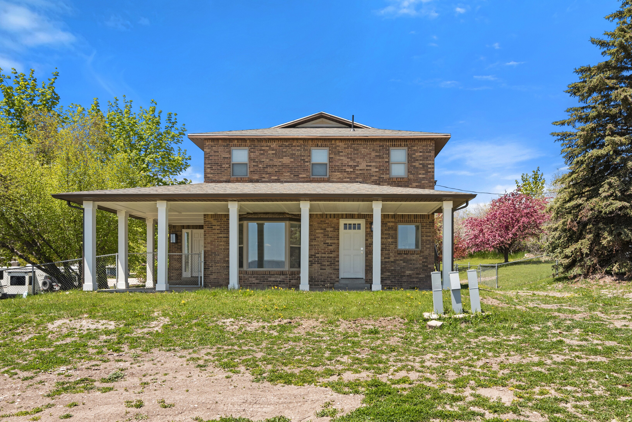 Welcome to this hidden gem in Garden City on over 1 acre of land! Short term rental approved and comfortably sleeps 24. A true turn key property! All furniture, TV's and airbnb essentials are included. This spacious 4-bedroom, 3-bathroom home offers the perfect blend of comfort and adventure. Located on a private drive, this property offers ample space for family gatherings, relaxation and recreation. Inside, you'll find a bright and airy living space, perfect for entertaining friends and family. The kitchen features modern appliances and plenty of counter space for meal preparation. Retreat to the cozy bedrooms after a day of exploration. The real gem of this property lies outside. With room for 3 RV or trailer with full hookups, you can easily accommodate guests or indulge your love for outdoor living. Easy access to a wealth of outdoor activities, from boating on Bear Lake to hiking in the nearby mountains. Don't miss your chance to make this stunning property your own oasis in the heart of nature!