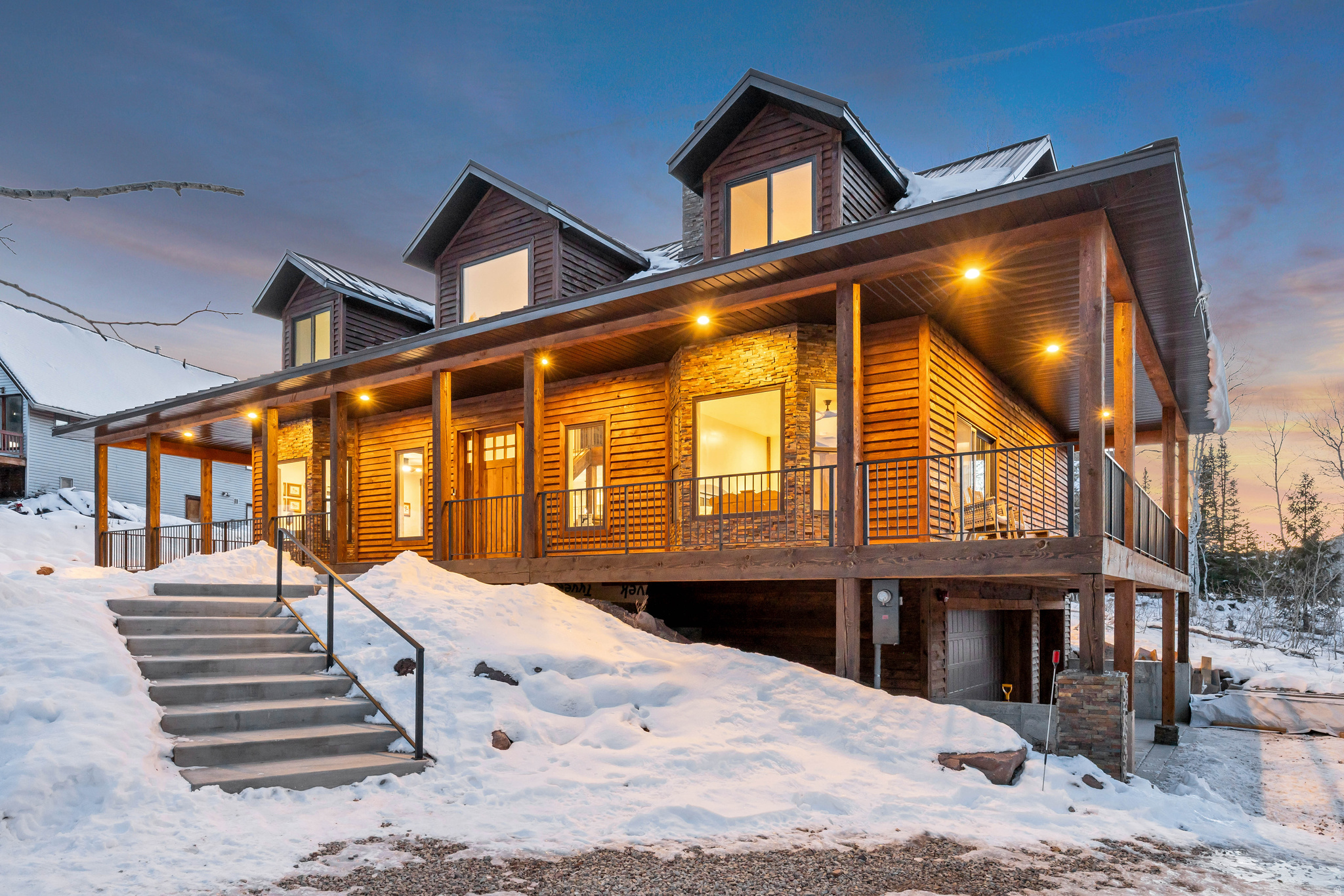 Welcome to a true luxury mountain residence in the exclusive, gated Pine Mountain subdivision of Oakley, Utah. Built in 2026 with uncompromising quality, this extraordinary 7-bedroom, 6-bathroom home offers exceptional craftsmanship, structural integrity, and breathtaking alpine views-just minutes from world-class skiing and snowboarding in Park City, and only 45 minutes from Salt Lake City. Designed for both luxury and durability, this home features 2x6 exterior walls, hybrid timber construction, Douglas fir beams throughout, engineered mountain snow-load design, cedar siding, Andersen 100 Series windows, solid knotty alder doors, and full spray-foam insulation in the walls and roofline-delivering superior strength, energy efficiency, and quiet interior comfort rarely found in mountain construction. The expansive open-concept floor plan is ideal for entertaining and family gatherings, showcasing luxury vinyl plank flooring, custom cabinetry, quartz countertops throughout, and a stunning chef's kitchen anchored by a massive 4' x 10' granite slab island. A full-height rock fireplace with Douglas fir timber mantle creates a dramatic focal point in the main living space. The home offers seven oversized bedrooms, including a custom-built bunk room, six full bathrooms, dual mudrooms, abundant storage, and a dedicated cold storage room. Premium systems include two high-efficiency furnaces, a large upgraded tankless water heater, high-end appliance packages, and a full smart-home and security system featuring high-definition live cameras and remote access from anywhere in the world. The oversized, extra-deep 3-car garage boasts a finished interior, sealed floors, and ample space for trucks, toys, and mountain gear. Outdoor living is exceptional with over 1,400 square feet of covered Trex decking wrapping around three sides of the home, plus a spacious rear patio ideal for entertaining while taking in the spectacular mountain views. Mature aspens and pine trees provide privacy and a true alpine setting. Residents of Pine Mountain enjoy outstanding community amenities, including gated access, maintained roads, biking and horse trails, pickleball courts, common RV parking, equestrian facilities, storage areas, and a community-staffed fire department, all supported by low association dues. Located just minutes from Smith & Morehouse Reservoir, Rockport Reservoir, and the Weber River, this home provides unmatched access to fishing, boating, hiking, hunting, and year-round recreation, with frequent sightings of deer, elk, and moose. This turn-key luxury mountain retreat is fully furnished, with furnishings negotiable. ATVs/side-by-sides are not included but may be negotiated separately. Rare Star Wars collectibles are also available for purchase outside of the real estate transaction. A rare opportunity to own a brand-new, meticulously crafted luxury mountain estate offering privacy, space, superior construction, and premier lifestyle-exceptional quality rarely found at this price point. **TO VIEW FULL MOTION VIDEO OF THIS HOME PRESS THE TOUR BUTTON***THIS HOME IS FEATURED ON TELEVISIONS REAL ESTATE ESSENTIALS ABC4 UTAH SUNDAYS AT 4:30PM *** Square footage figures are provided as a courtesy estimate only. Buyer is advised to obtain an independent measurement & verify all info.