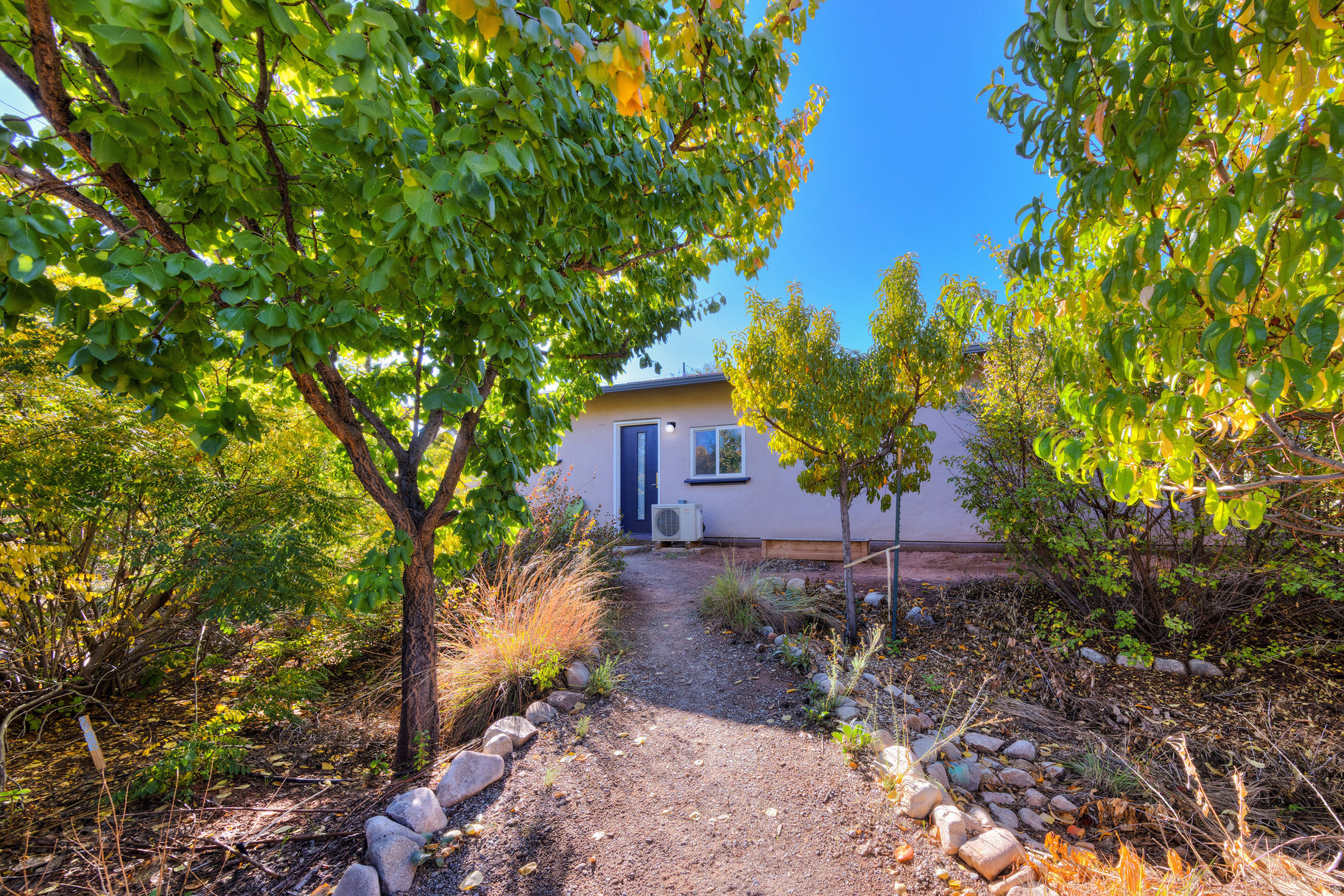 Carefully Crafted Sustainability meets Moab Living!   Thoughtfully built straw bale home offering efficiency, comfort, and character. This three-bedroom residence features thick natural walls that provide excellent insulation and a quiet, solid feel you won't find in conventional construction. The kitchen was designed with cooking and gathering in mind and features a hickory island that anchors the space. The home includes one full bathroom and one three-quarter bath. An integrated solar system helps offset energy costs, and a grey water system serves the bathtub and washing machine for added sustainability.  The backyard is set up for both enjoyment and entertaining, plus fruit and veggie production. A well-established pollinator garden supports local wildlife, alongside garden beds and mature fruit trees that provide seasonal harvests. A terraced patio creates an easy outdoor living space, and two large sheds provide room for storage, hobbies, or workspace.  This cozy home blends efficient design with functional outdoor living.