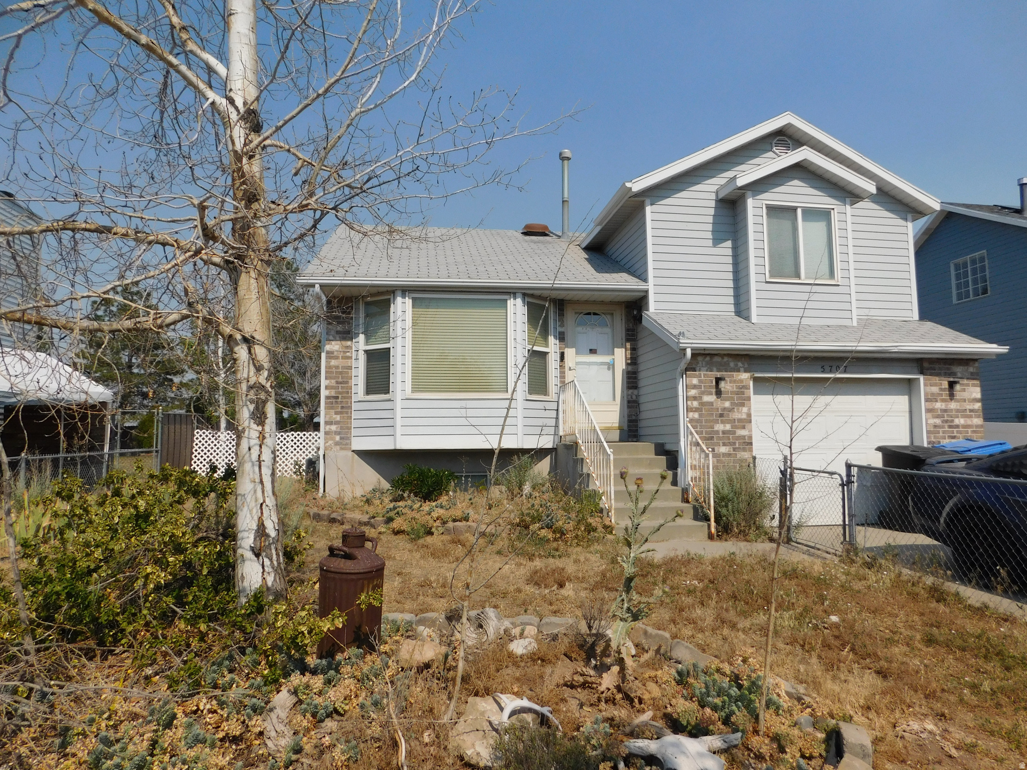 This home was built in 1989 and offers 1,463 square feet with 2 bedrooms and 1 full bathroom. The basement is plumbed for an additional bathroom and bedroom, providing opportunities for future expansion. Situated on a 0.16-acre lot, the property includes a spacious backyard with an extended patio. Kitchen appliances are included. Additional features include a deep 1-car garage, RV parking, and a newer furnace and AC.