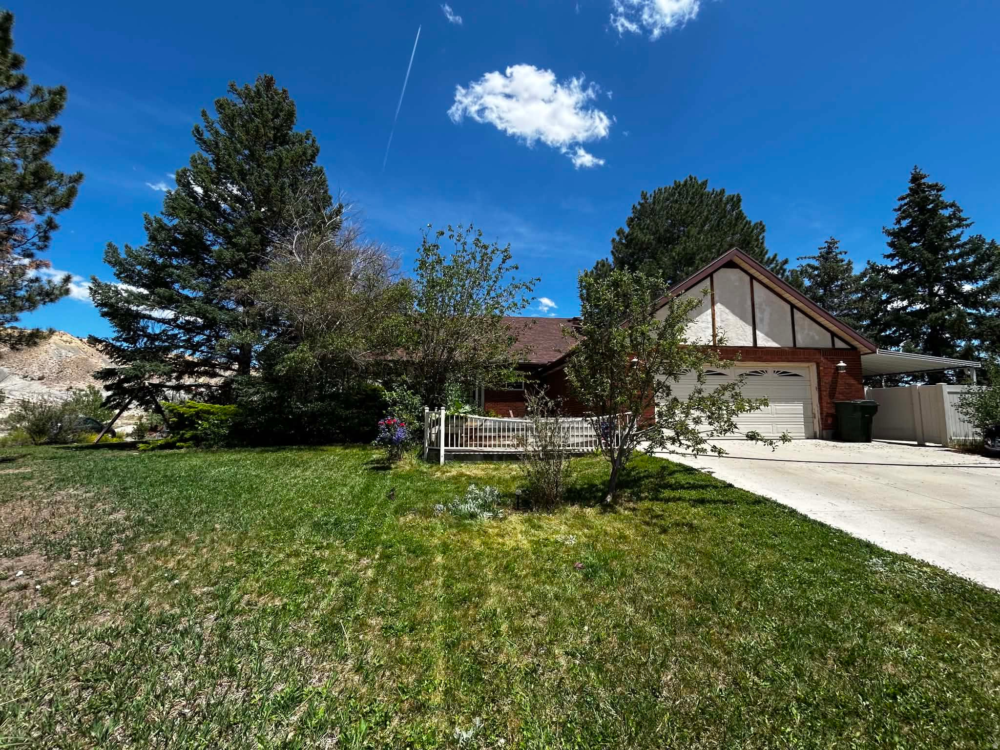 This beautiful two-story home on a corner lot near the Carbon County hills offers space, updates, and endless potential! Inside, you'll find an open floor plan filled with natural light, updated kitchen cabinets and countertops, newerhardwood flooring, fresh paint, windows and more. The main-level primary suite features a walk-in shower for added convenience and comfort. The unfinished walkout basement gives you the opportunity to create the living space of your dreams ; whether it's additional bedrooms, a family room, home theater, gym, or game room. With abundant storage on every level, there is room for everything. Step outside and enjoy the covered side patio, perfect for entertaining, BBQs, or simply relaxing while taking in the peaceful surroundings. The spacious yard offers plenty of room for gardening, outdoor activities, and play. This property combines comfort, functionality, and future possibilities all in one great location!  Square footage figures are provided as a courtesy estimate only and were obtained from _Carbon County_ .  Buyer is advised to obtain an independent measurement.