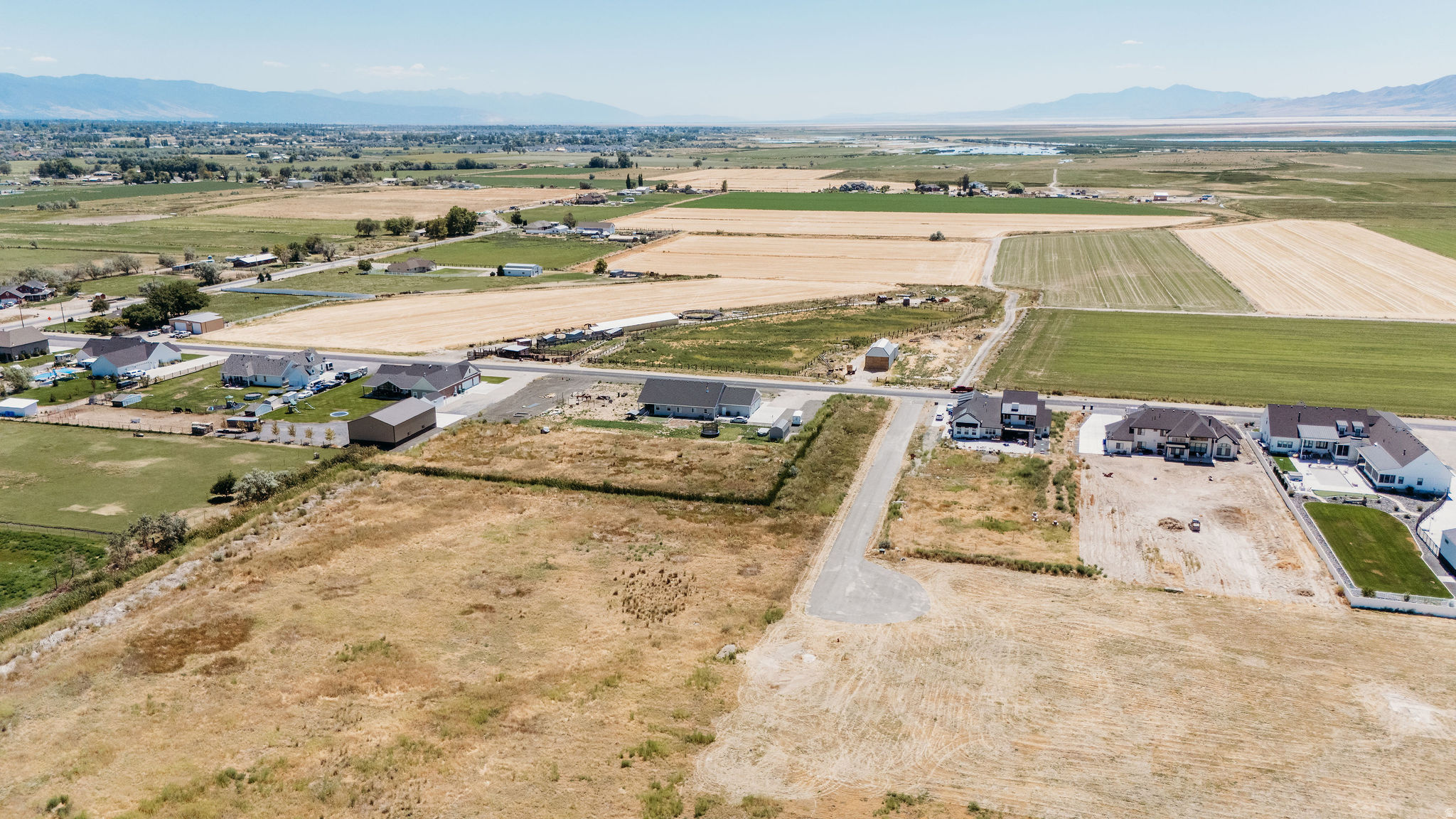 Ready-to-Build 2.271-Acre flag lot in West Point ideal for country living with city conveniences. The east-facing, flat property offers mountain views, a tranquil setting, and quick access to the West Davis Corridor. It is suitable for building a custom home, hobby farm, or equestrian needs, with no HOA or CCR restrictions. Utilities are in place including power, gas and water (culinary and secondary). A completed perk test, a statement of feasibility, and the wastewater application have all been filed with Davis County and the Davis County Health Department. This lot is perfect for those seeking a rural lifestyle with flexibility and city amenities.