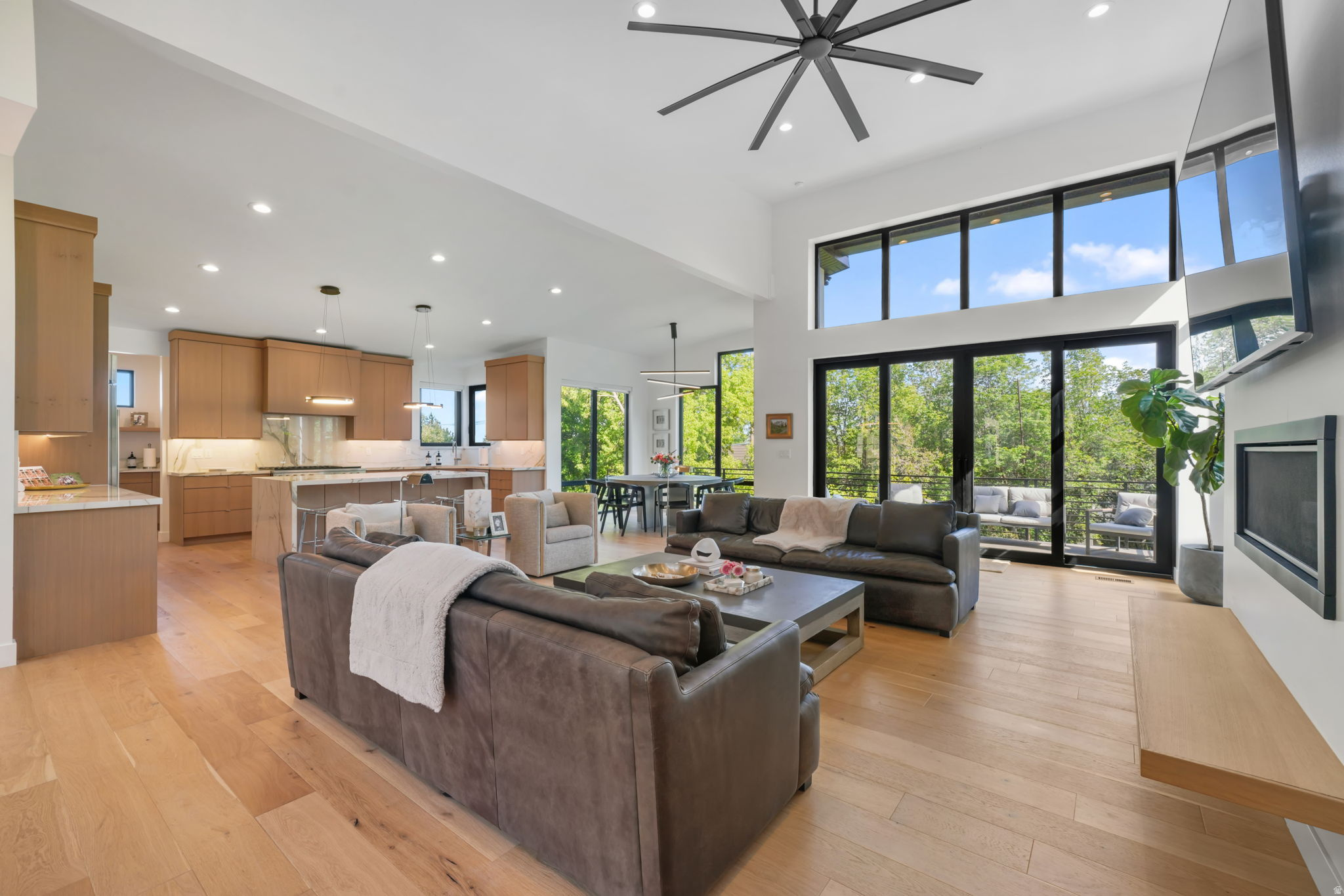 Welcome to this custom home at the base of Little Cottonwood Canyon, offering incredible mountain views and a prime location with high-quality finishes throughout. The open layout connects the living, dining, and kitchen areas, with large windows and sliding doors bringing in natural light and showcasing the views. The kitchen features white oak cabinets, a large island, commercial-grade appliances, and a spacious butler's pantry. With three kitchens and three laundry hookups, the home provides flexible options for multi-generational living, guests, or a caretaker setup. The garage includes vaulted ceilings, excellent lighting, and a separate apartment underneath. Ample parking and a private gated entrance add convenience and privacy. All figures are provided as a courtesy estimate only. Buyer is advised to obtain an independent measurement.