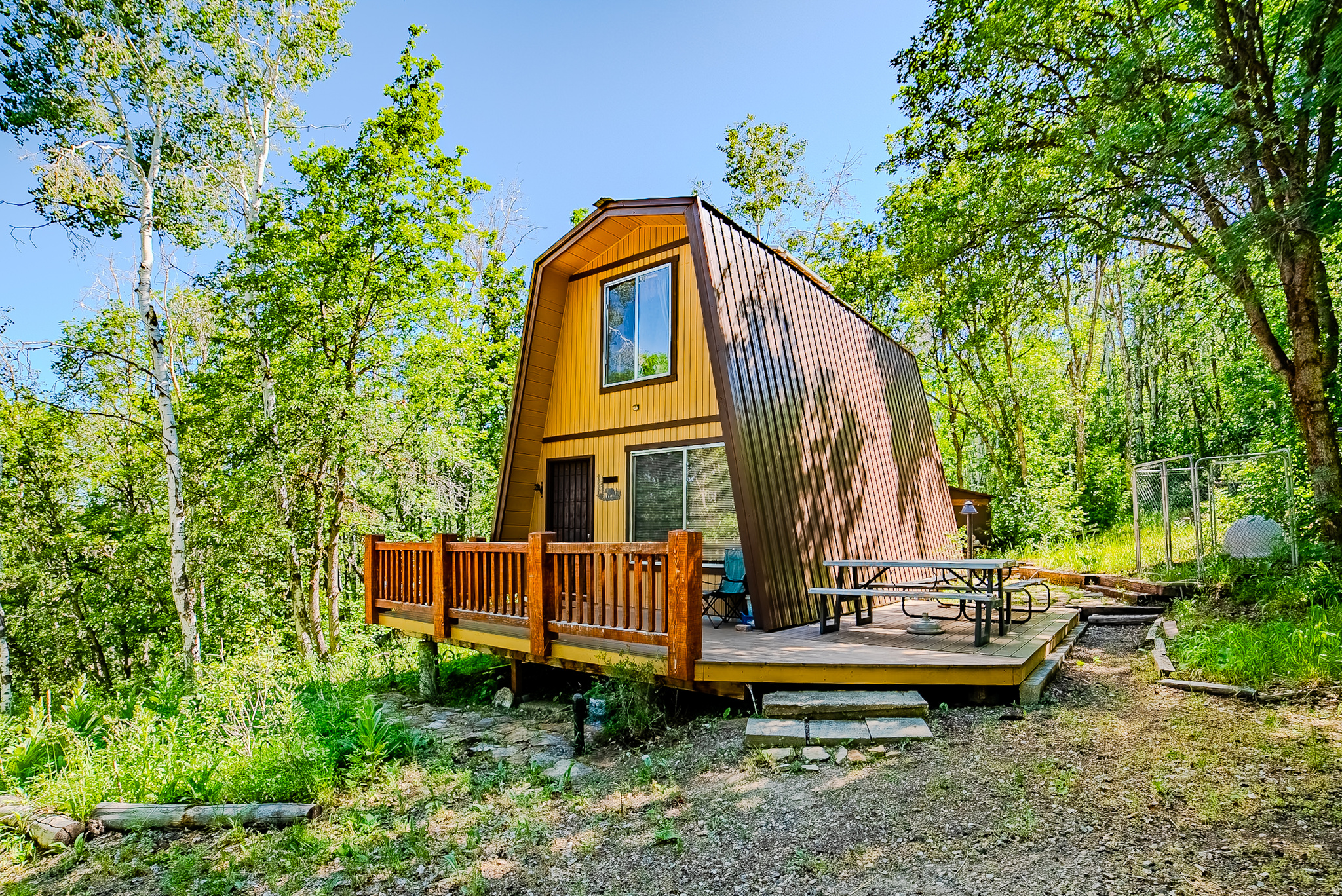 Escape to your own private mountain retreat in the desirable Aspen Hills community! Nestled on nearly 3 wooded acres spanning 4 contiguous lots, this charming cabin offers the perfect balance of peaceful seclusion, natural beauty, and outdoor adventure. Surrounded by mature maple, aspen, and a stunning grove of oak trees, the property provides a picturesque setting with abundant wildlife, fresh mountain air, and breathtaking star-filled nights. The well-maintained cabin features comfortable living space and a turnkey off-grid setup, including solar power with generator backup, a large underground water cistern, septic system, propane storage, and electric hot water, making it an ideal weekend getaway or year-round escape. A second driveway leads to a large improved parking area, offering excellent flexibility for trailers, guests, recreational vehicles, or potential future expansion. Two outbuildings provide ample storage for tools, equipment, and outdoor gear. Located behind a gated entrance with community road maintenance and common area access, this property offers privacy and convenience while remaining just a short drive from the amenities of Mount Pleasant and Fairview. Whether you're seeking a mountain getaway, hunting basecamp, or a place to unplug and reconnect with nature, this Aspen Hills property is a rare opportunity to own your own slice of Utah mountain paradise.  Buyer is advised to independently verify all measurements and property information to their satisfaction