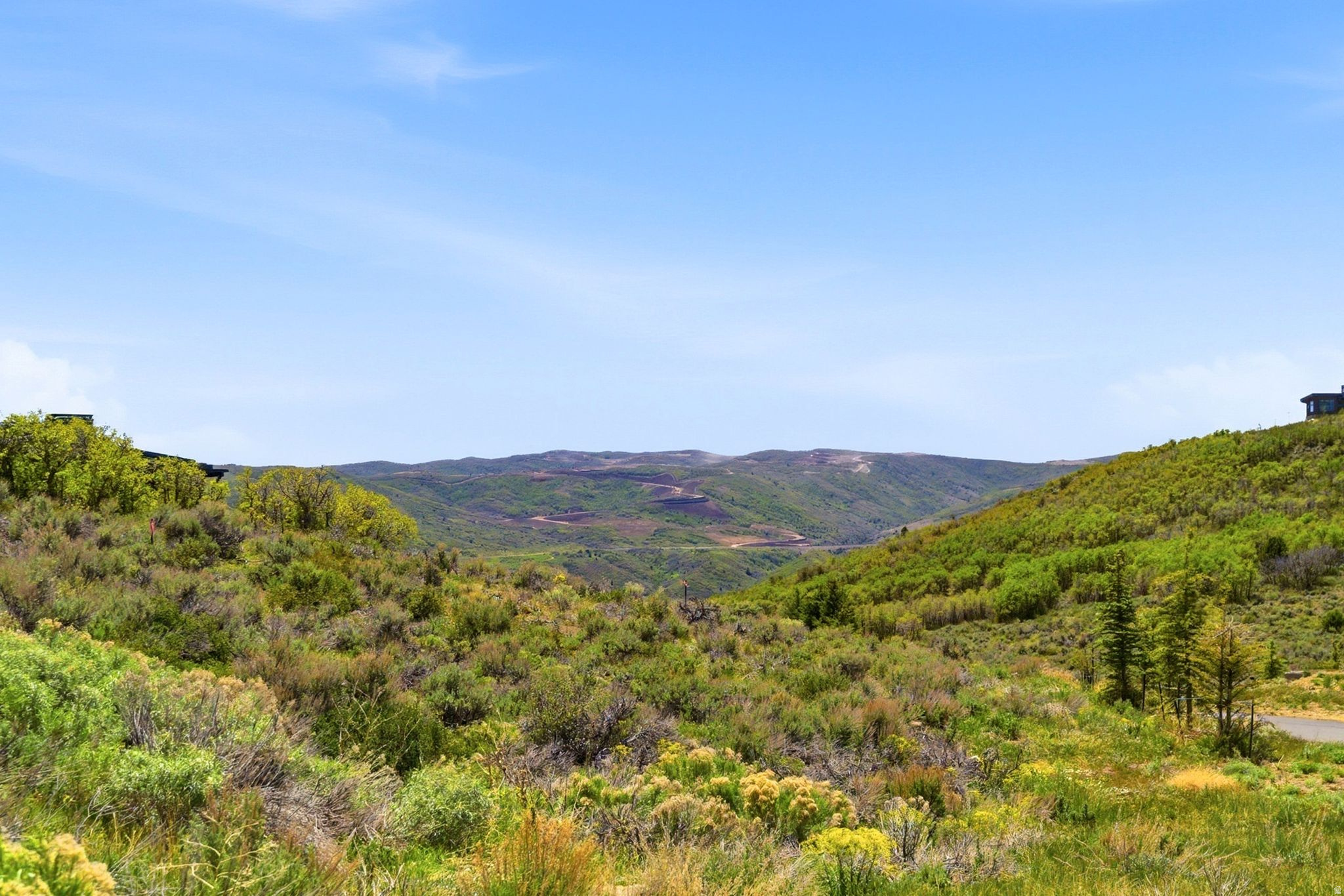 Discover this stunning south-facing homesite in Tuhaye, perfectly positioned to capture views down a serene natural draw and the breathtaking mountain landscape beyond. This exceptional downhill building site offers convenient access in and out of Tuhaye, along with close proximity to the Club's premier amenities. Enjoy a short walk to Moondance Park and the Pavilion, or head out on the Hoodoo Trail for a scenic hike down to the Jordanelle. The list price INCLUDES $200,000 for the Talisker Club Membership initiation/joining fee, offering access to an extraordinary four-club lifestyle. Talisker Club spans Tuhaye, Empire Pass, Courchevel Bistro on Main Street, and The Outpost--delivering a rare combination of mountain recreation, private golf, ski-in/ski-out access, dining, wellness, and adventure. In Tuhaye, residents enjoy the Signature Mark O'Meara championship golf course, the Village at Tuhaye Golf Clubhouse, pools, spa, fitness center, tennis courts, Moondance Park, and miles of hiking and biking trails. At Empire Pass, members enjoy access to the private Talisker Tower Clubhouse with ski-in/ski-out convenience. Courchevel Bistro offers a private members-only lounge in the heart of Old Town, while The Outpost provides a backcountry escape with a private yurt, snowmobiling, snow tubing, private dinners, hiking, and more.