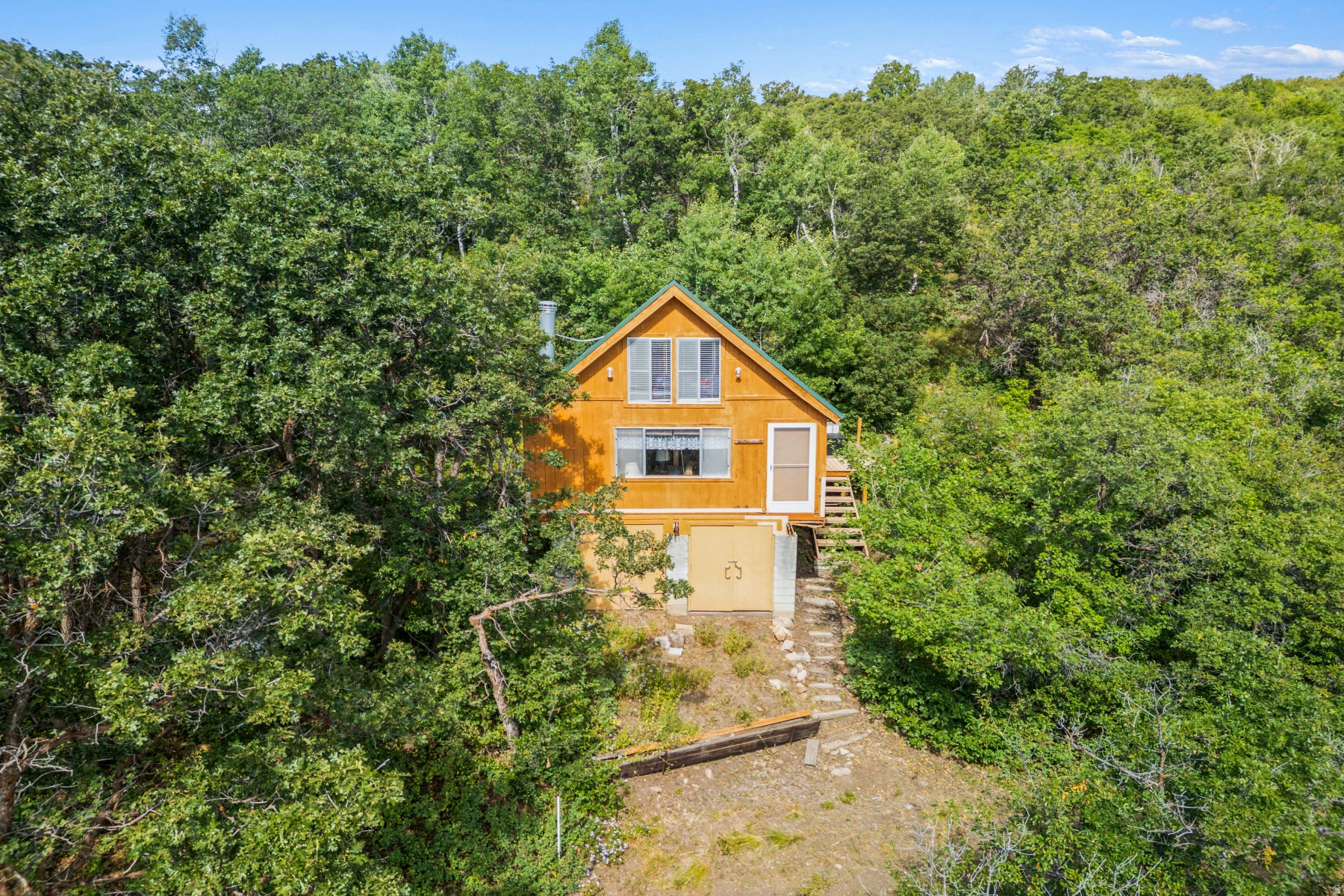 Heritage Cabin on just under 11 Acres in Stagecoach Estates  Park City School District. Discover the perfect mountain escape with this charming Heritage Cabin located in the private, gated community of Stagecoach Estates. Set on 10.36 acres of wooded land, this property offers stunning panoramic views-from Park City to the west to the Uinta Mountains to the east-creating a truly one-of-a-kind retreat. The existing cabin is equipped with essential utilities, including a wood burning stove, water, propane, and a private septic system. The land features a gentle slope, abundant sunshine, and multiple view corridors, making it ideal for a future custom estate designed to embrace indoor-outdoor living. Wildlife abounds in this serene setting, with frequent sightings of moose, elk, and deer. Stagecoach Estates offers the rare combination of seclusion, year-round access via maintained roads, and proximity to Park City's world-class skiing, dining, golf courses, and mountain trails. This exceptional property provides a unique opportunity to enjoy the cabin today while planning for tomorrow. Whether you envision a legacy mountain estate or a peaceful getaway, this parcel is ready for your vision. Square footage figures are provided as a courtesy estimate only and were obtained from county records. Buyer is advised to verify all information.