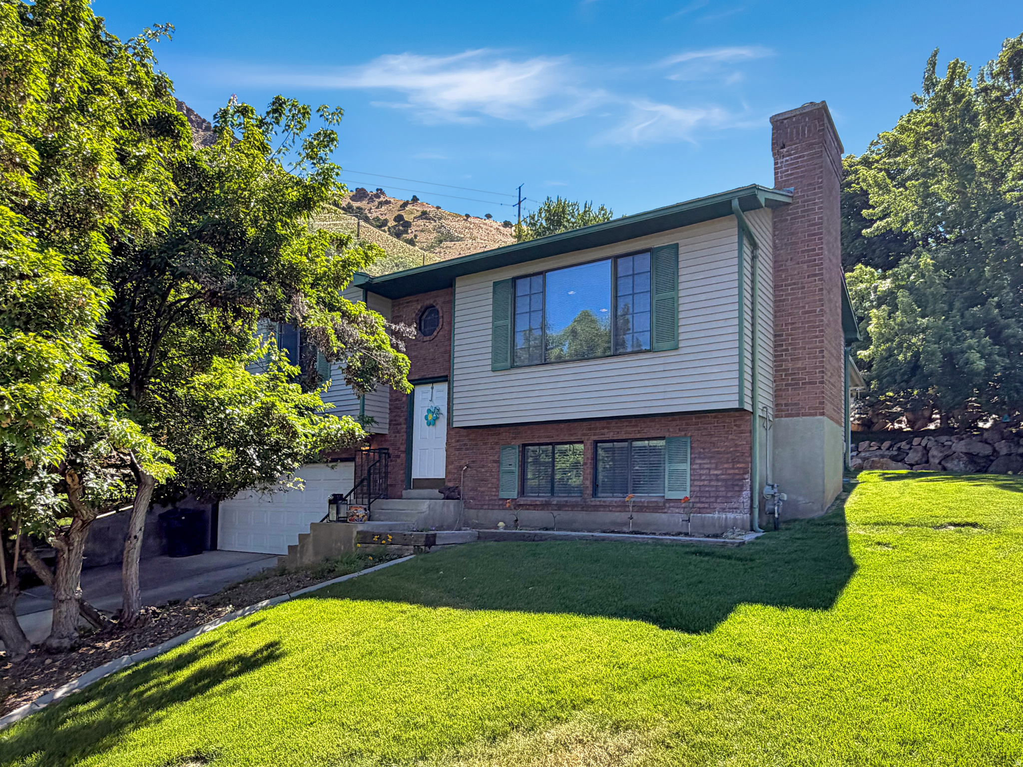 Have you been waiting for your own piece of paradise?  This just might be it!  Located on a roomy half an acre in a quiet cul-de-sac, you are going to love this home.   Perched on the mountain with wide open space behind you this home has a covered patio, basketball court and an outdoor shed.  There is also a fenced garden or dog run.   The home has four bedrooms, updated bathrooms, a cozy downstairs family room with a gas fireplace and a nice open kitchen and living area.   The dining room opens onto the patio.   The garage also has a nice workbench.   Don't wait to schedule your tour of this home today!
