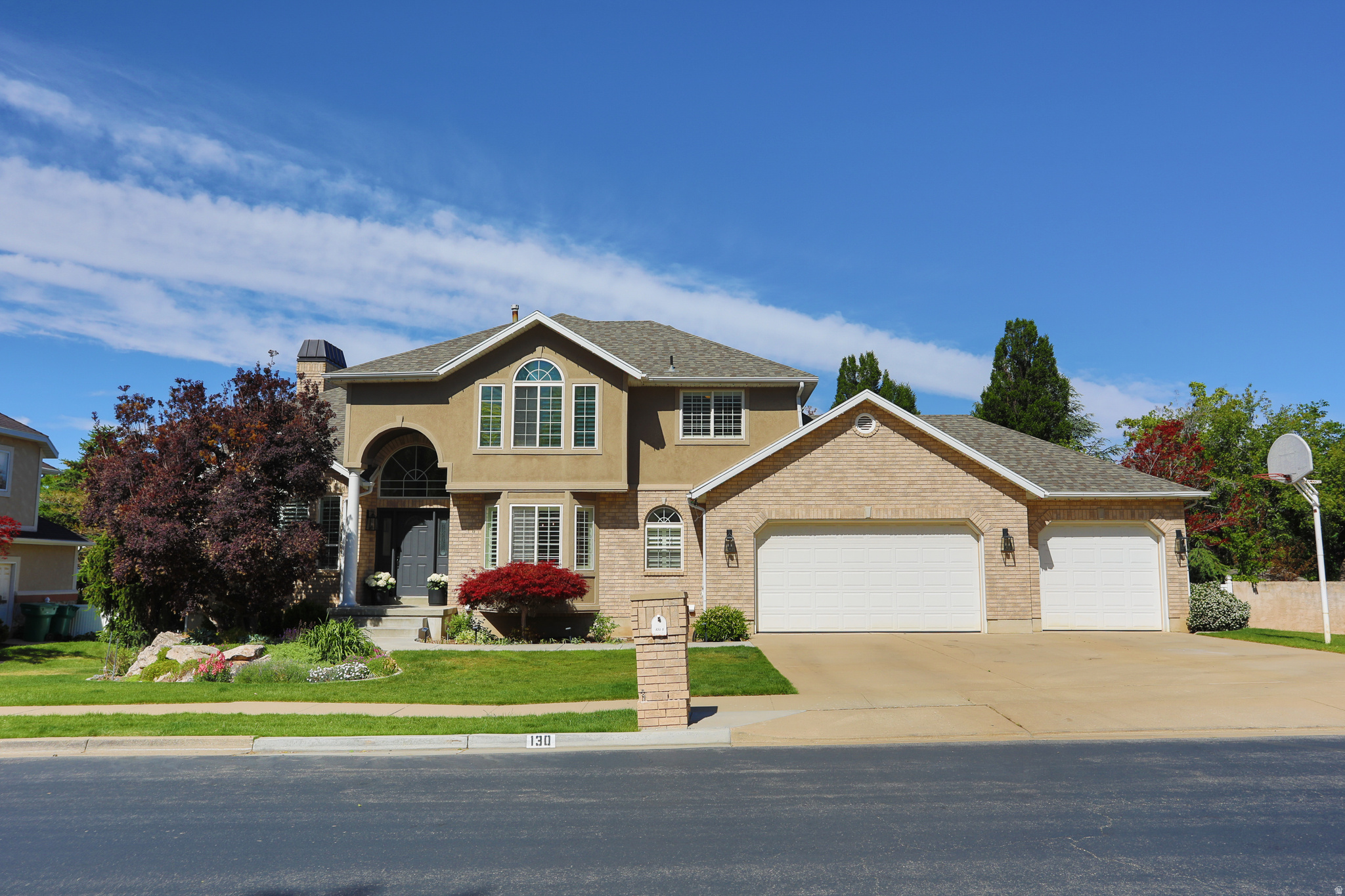 A Stunning, designer two-story in Southeast Layton with a view, in a manicured neighborhood! Recently remodelled with white oak engineered flooring throughout the main floor, new trim, new paint, a kitchen that will stop you in your tracks with it's custom cabinets, quartz countertops, luxury appliances, custom stone backsplash, massive picture window that overlooks a manicured yard, and the valley-- A very open concept through the kitchen, dining, & great room that flows out to a large covered trex deck for maximum indoor--> outdoor living. Enjoy a recently finished walk out basement that includes a surround sound entertainment center in the family room, a second laundry, an ensuite, and an additional bedroom. The backyard is lush with flowers, trees, garden boxes, & a sprawling lawn. Main floor reflects an extra 45 sq ft from the 9x5 pantry that was recently added.