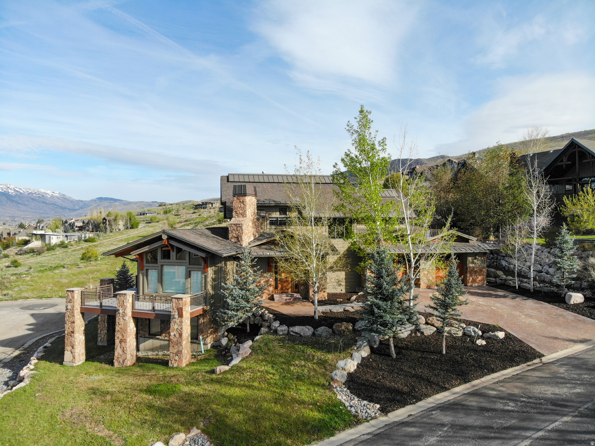 Experience mountain living at its finest in this beautifully maintained and thoughtfully upgraded home, perfectly positioned to capture breathtaking panoramic views of Pineview Reservoir, Snowbasin's majestic peaks, and panoramic views of the valley below.  This stunning property blends comfort with functionality. The exterior has been freshly painted in 2025, along with the deck, creating a crisp, modern mountain aesthetic. Major upgrades provide peace of mind, including a new HVAC system in the ADU, all three water heaters purchased in 2025, and a 2020 addition of a covered back patio roof-perfectly designed to enjoy the private hot tub year-round. All exterior doors have also been upgraded for enhanced efficiency and style. This home also includes a central vac and water softener systems.  Inside, you'll find like-new carpet and wood flooring throughout and radiant heated floors on the lower level, offering warmth and comfort during every season. The spacious primary suite is a true retreat, featuring a private sitting area and an additional closet for ample storage.   The lower level boasts an impressive 500+ sq ft upgraded theater room, outfitted with a 120" screen, 7-channel surround sound system, 4K projector, and recessed lighting covers for a premium, cinema-quality experience.   The design of this home works great for large families or guests to occupy each level and enjoy spacious bedrooms with en suite baths and gathering rooms.  Car enthusiasts and outdoor adventurers will appreciate the two separate oversized 2-car garages, both with extra-tall ceilings and width, which is ideal for additional storage or accommodating larger vehicles such as RVs. The second garage entrance is from the cul-de-sac. Both driveways were plumbed for heat to add convenience during snowy winter months.  This home offers a separate one-bedroom ADU (Accessory Dwelling Unit), perfect for private guest accommodations or a mother-in-law suite with its own entrance from inside the main garage.  Located in the Wolf Creek Resort area just 5 miles from Powder Mountain Ski Resort.  This property offers unparalleled access to year-round recreation while maintaining privacy and serenity and no monthly HOA fees.  Whether you're looking for a full-time residence or a vacation retreat, this exceptional mountain home delivers on every level.