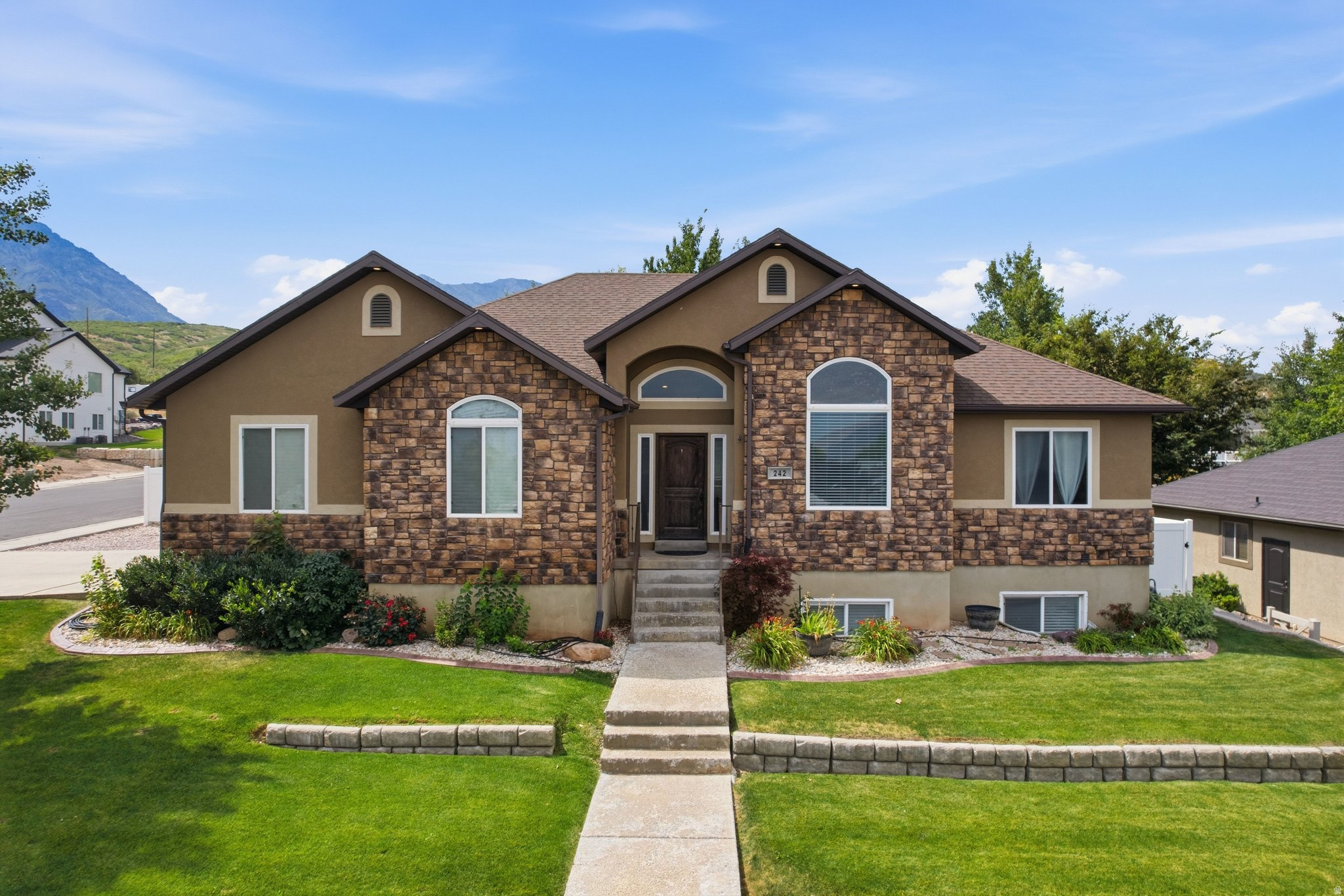 Welcome to this beautifully maintained home on Santaquin's highly desirable east bench, where breathtaking mountain views, small-town charm, and convenient I-15 access come together. Step inside to a bright, open-concept floor plan featuring vaulted ceilings, a cozy fireplace, and freshly painted main living areas. The fully finished walkout basement offers exceptional flexibility with three additional bedrooms, a full bathroom, and a spacious storage room. Enjoy peace of mind with numerous recent upgrades, including a new furnace and central air conditioning, water heater, dishwasher, and smart garage door, providing modern comfort and long-term value. Outside, the fully fenced, beautifully landscaped backyard complete with mature aspen trees, sandbox, swing set, and firepit. Gated RV and trailer parking offers ample space for recreational vehicles, boats, trailers, or extra parking. Ideally located just minutes from Theodore Ahlin Park, Pole Canyon, Santaquin Canyon, and Orchards Hills Elementary.